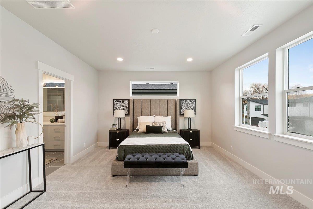 Carpeted bedroom featuring recessed lighting and ensuite bathroom