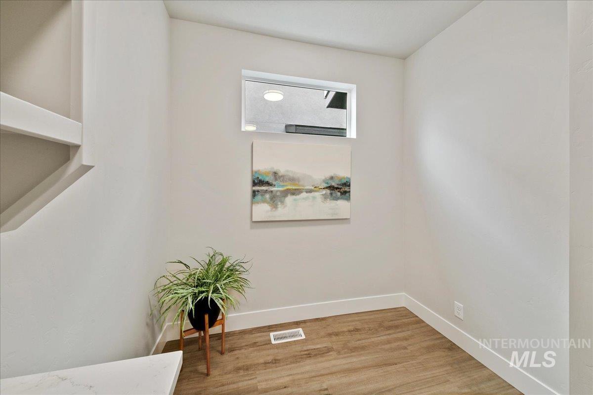 Detailed view of baseboards and wood finished floors