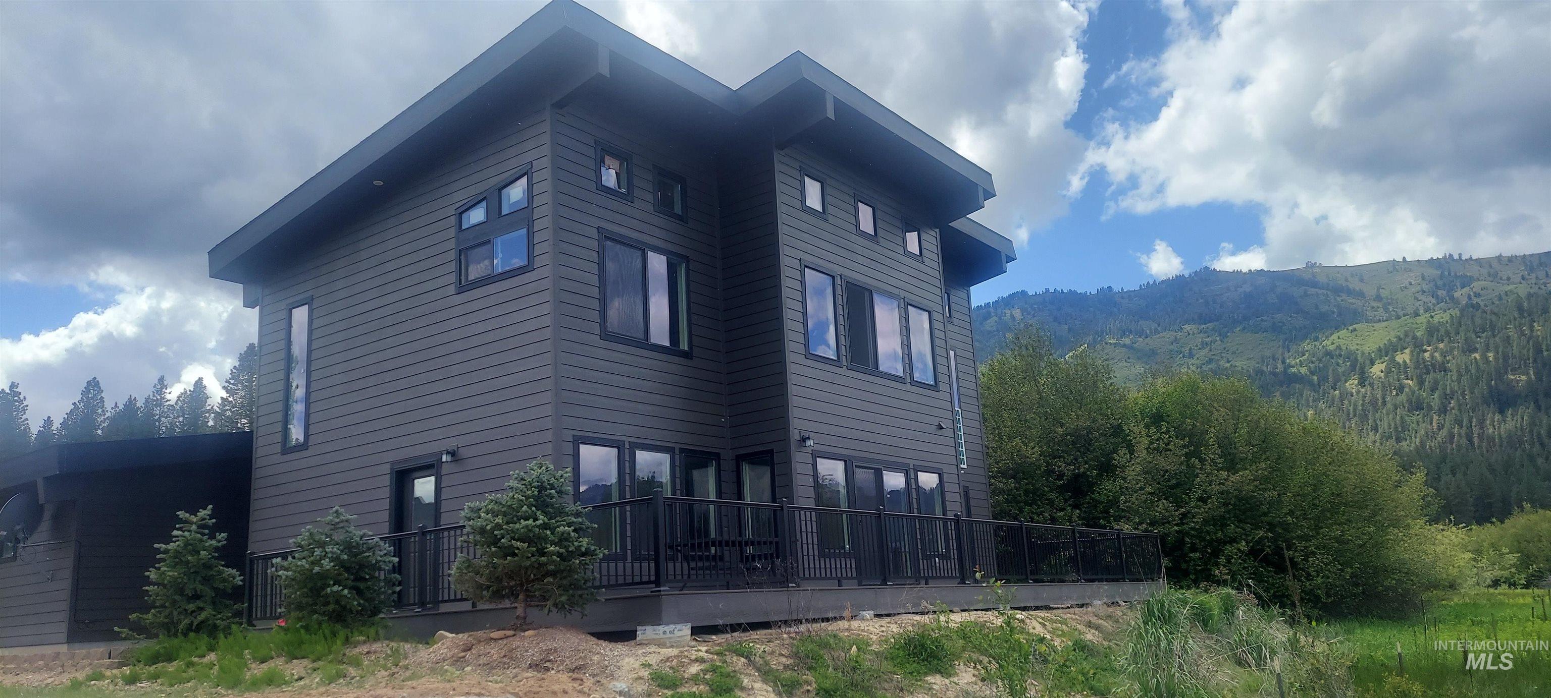 View of home's exterior with a deck with mountain view