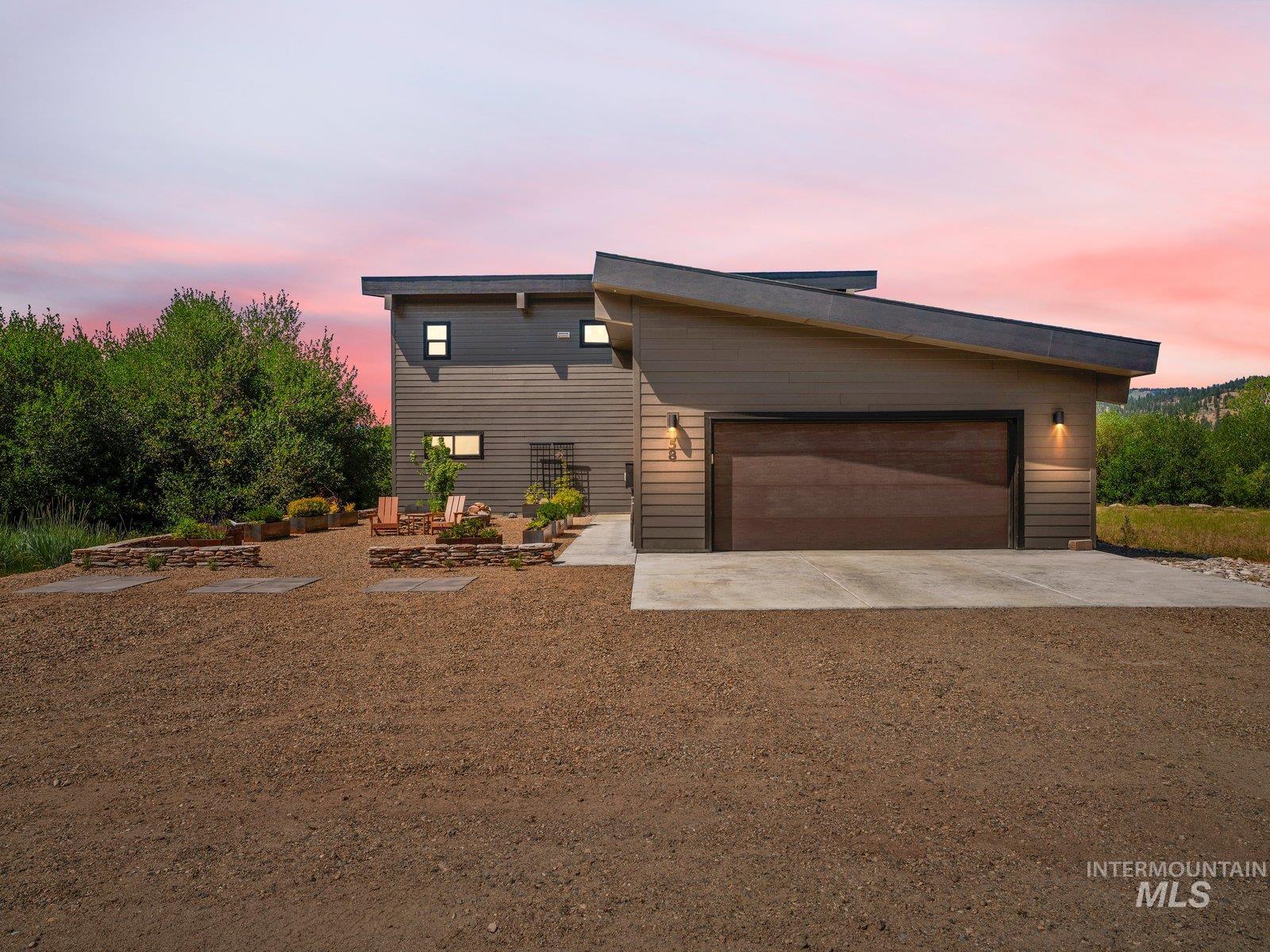 View of front facade with driveway and a garage