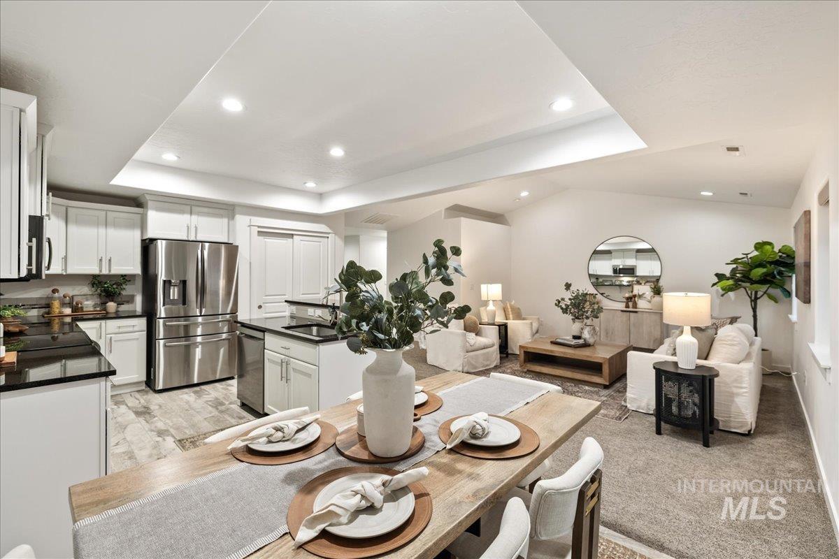 Dining space featuring recessed lighting and a tray ceiling