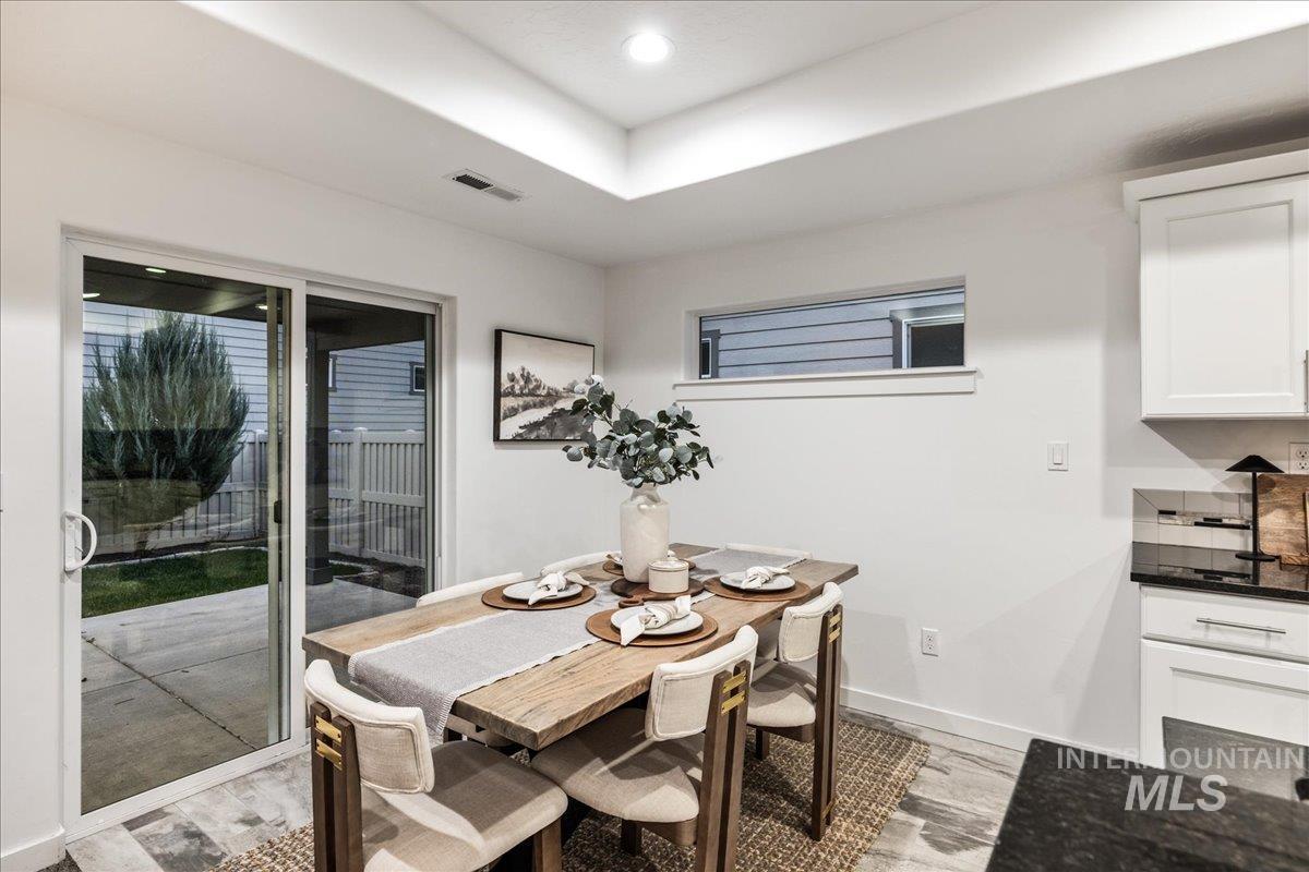 Dining space with light wood-style flooring and recessed lighting