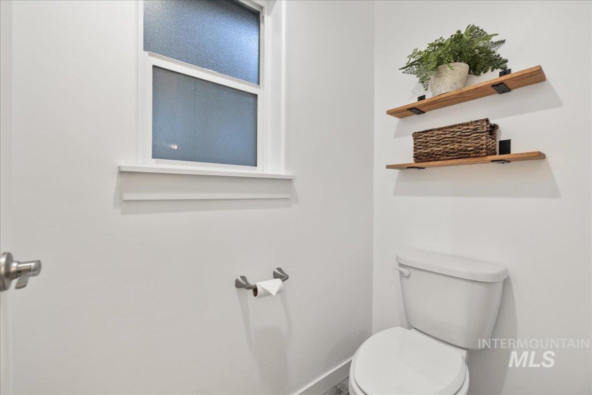 Bathroom featuring toilet and baseboards