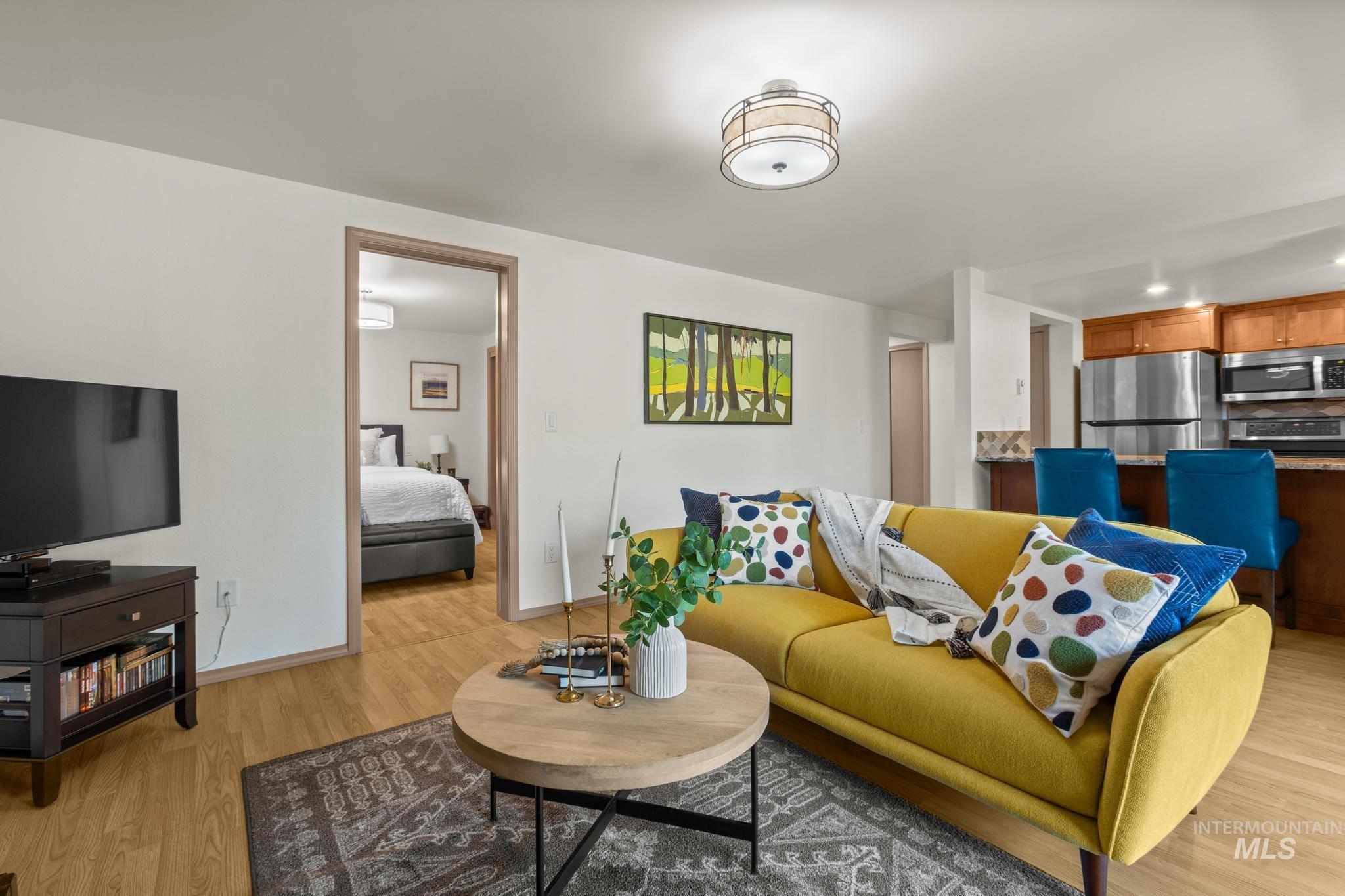 Living area featuring light wood-type flooring and recessed lighting