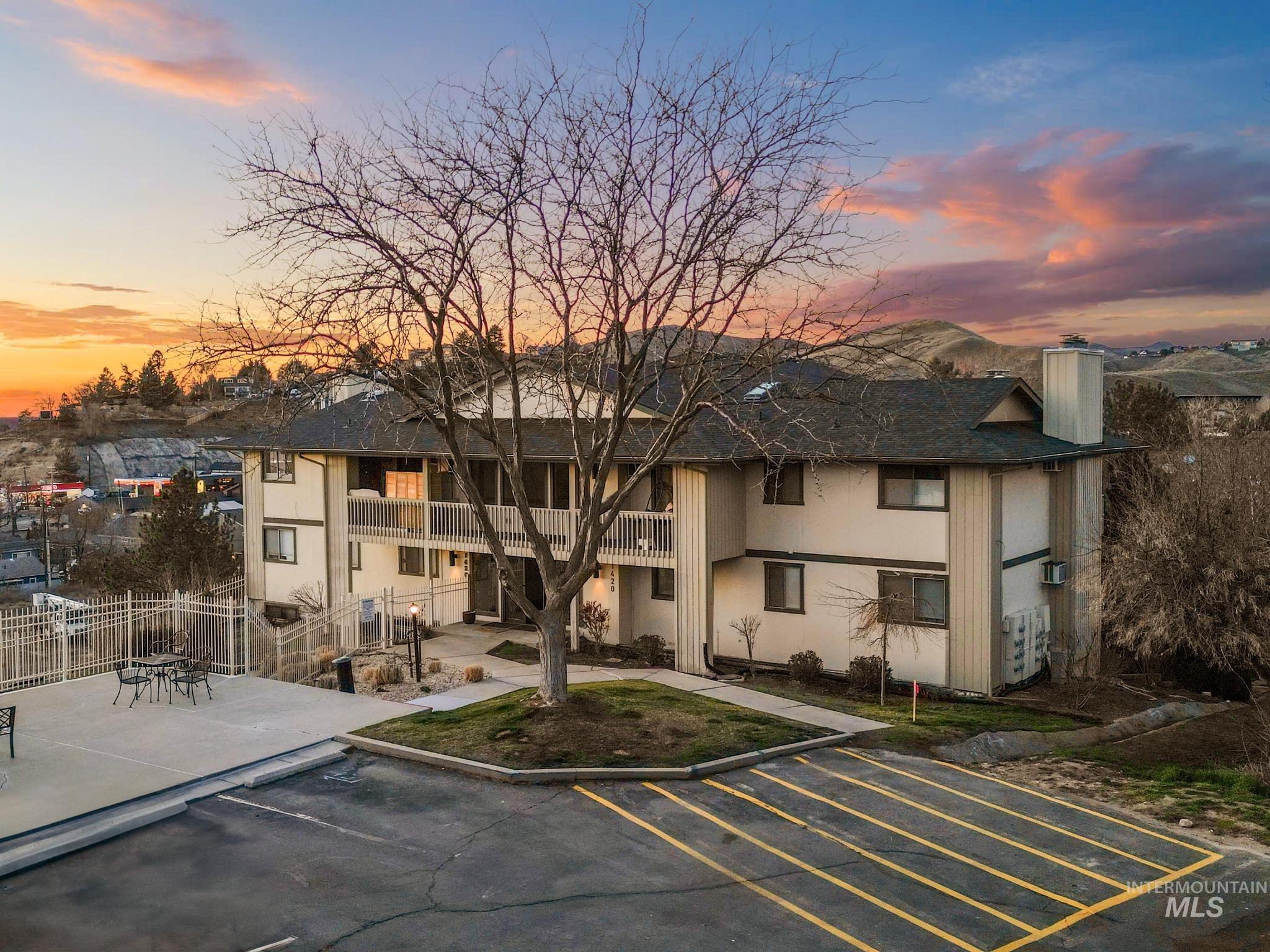 Property at dusk with uncovered parking