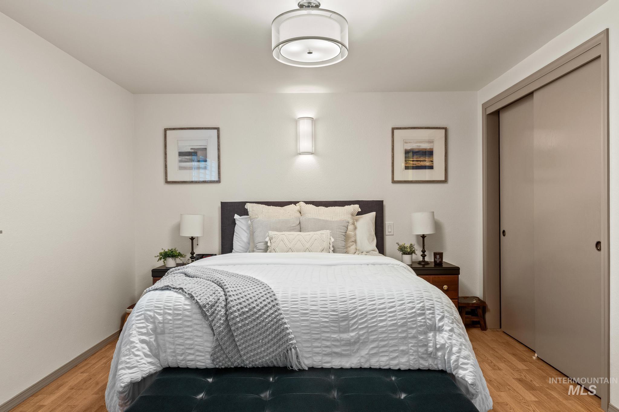 Bedroom with a closet and light wood finished floors