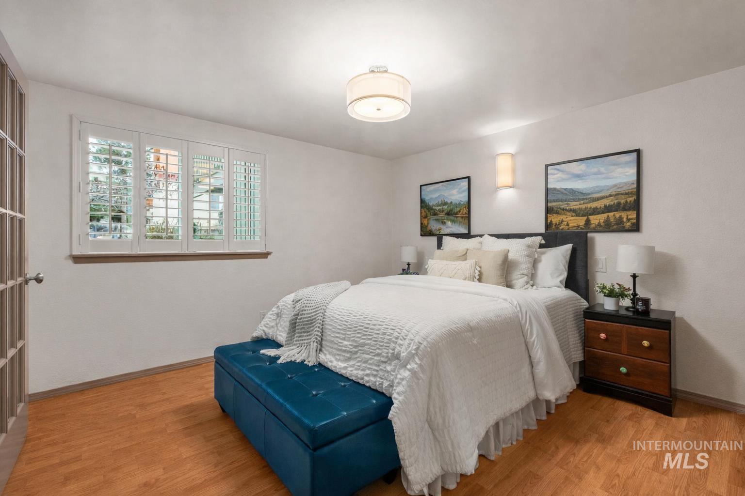 Bedroom with light wood-type flooring and baseboards