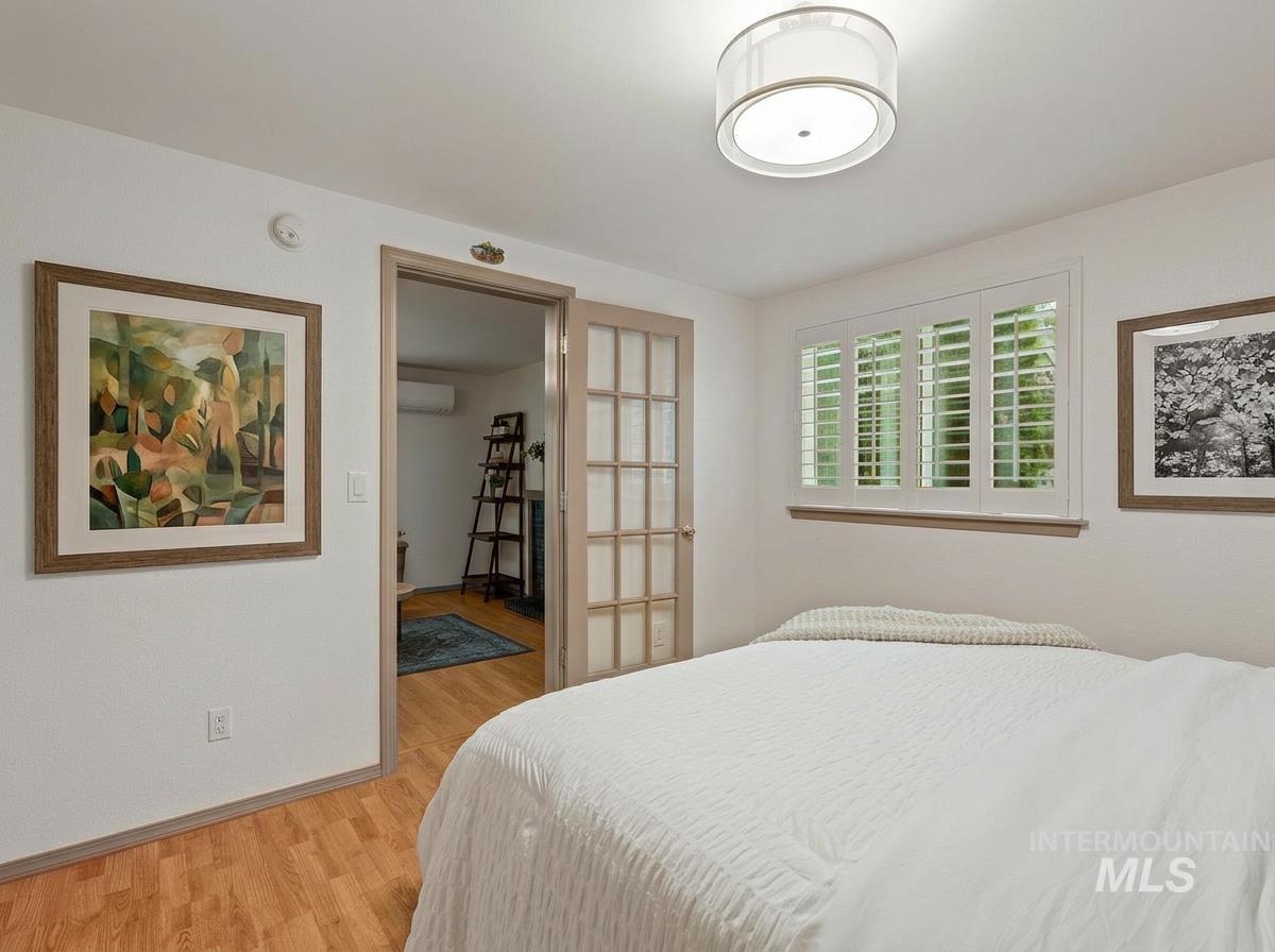 Bedroom featuring light wood-style flooring and baseboards