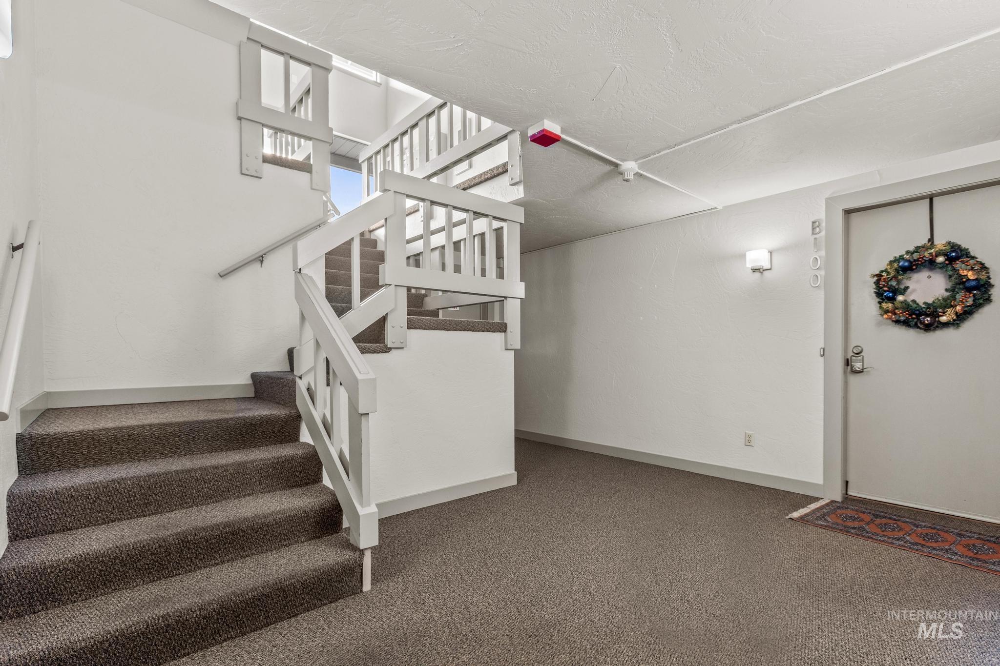 Stairway with baseboards and carpet