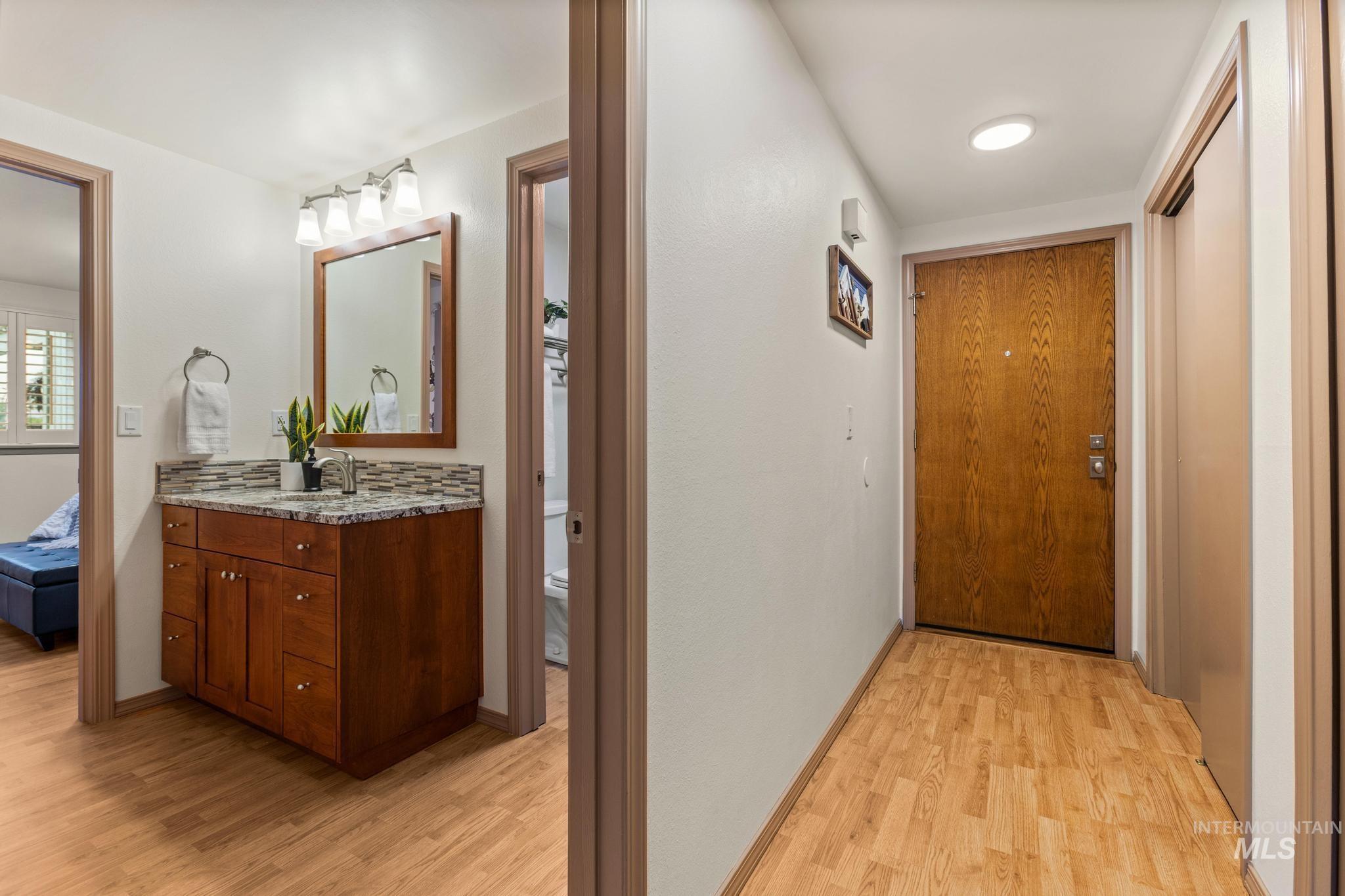 Corridor featuring light wood-style floors and baseboards