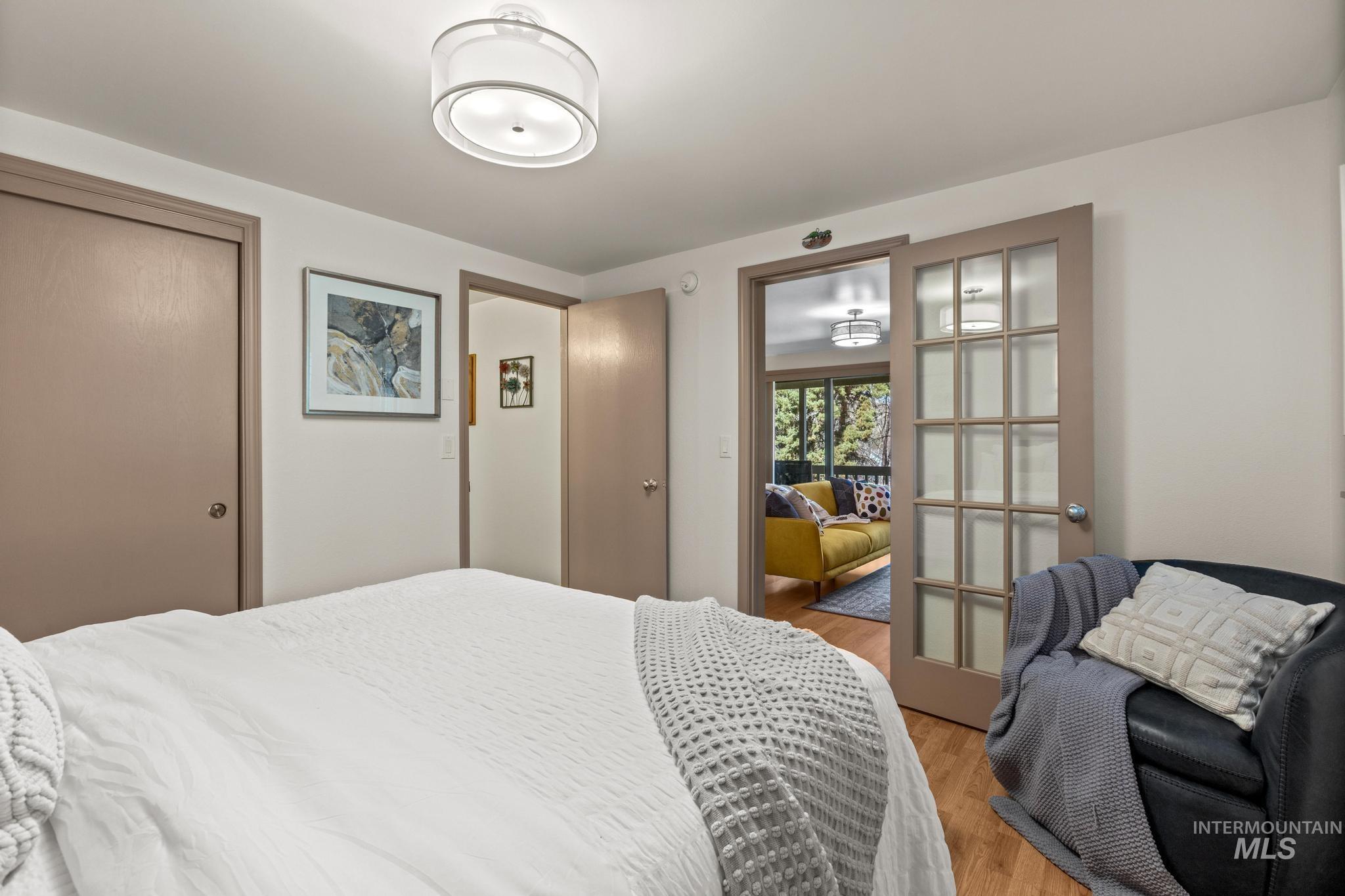 Bedroom featuring wood finished floors and a closet