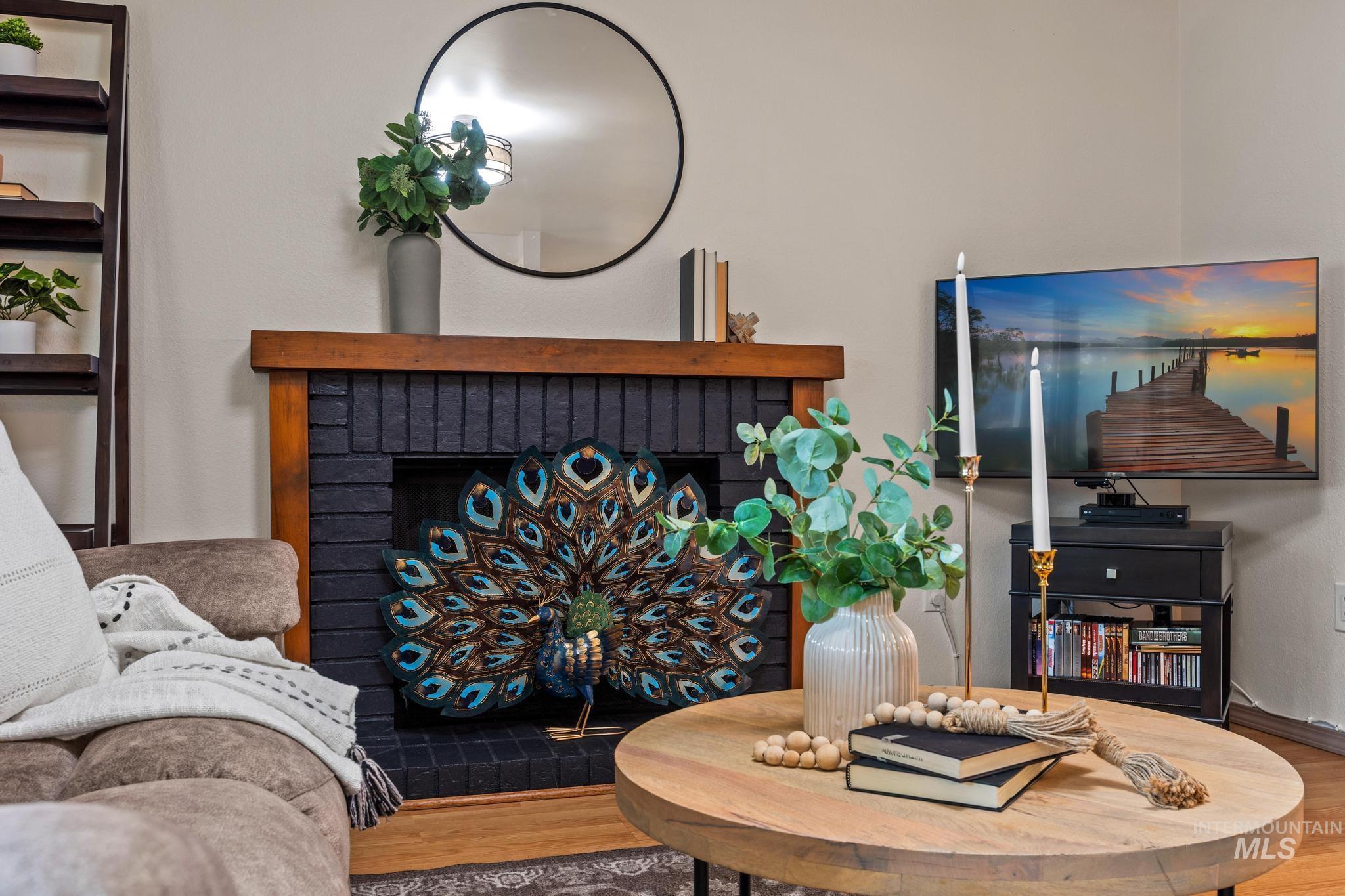 Living area with wood finished floors and a fireplace