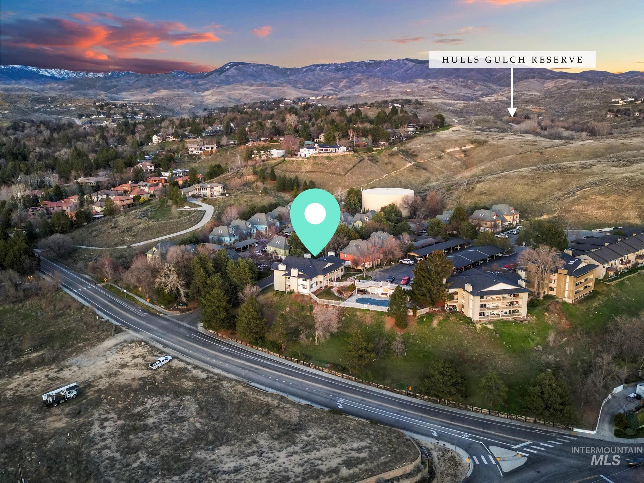 Aerial overview of property's location with mountains and nearby suburban area