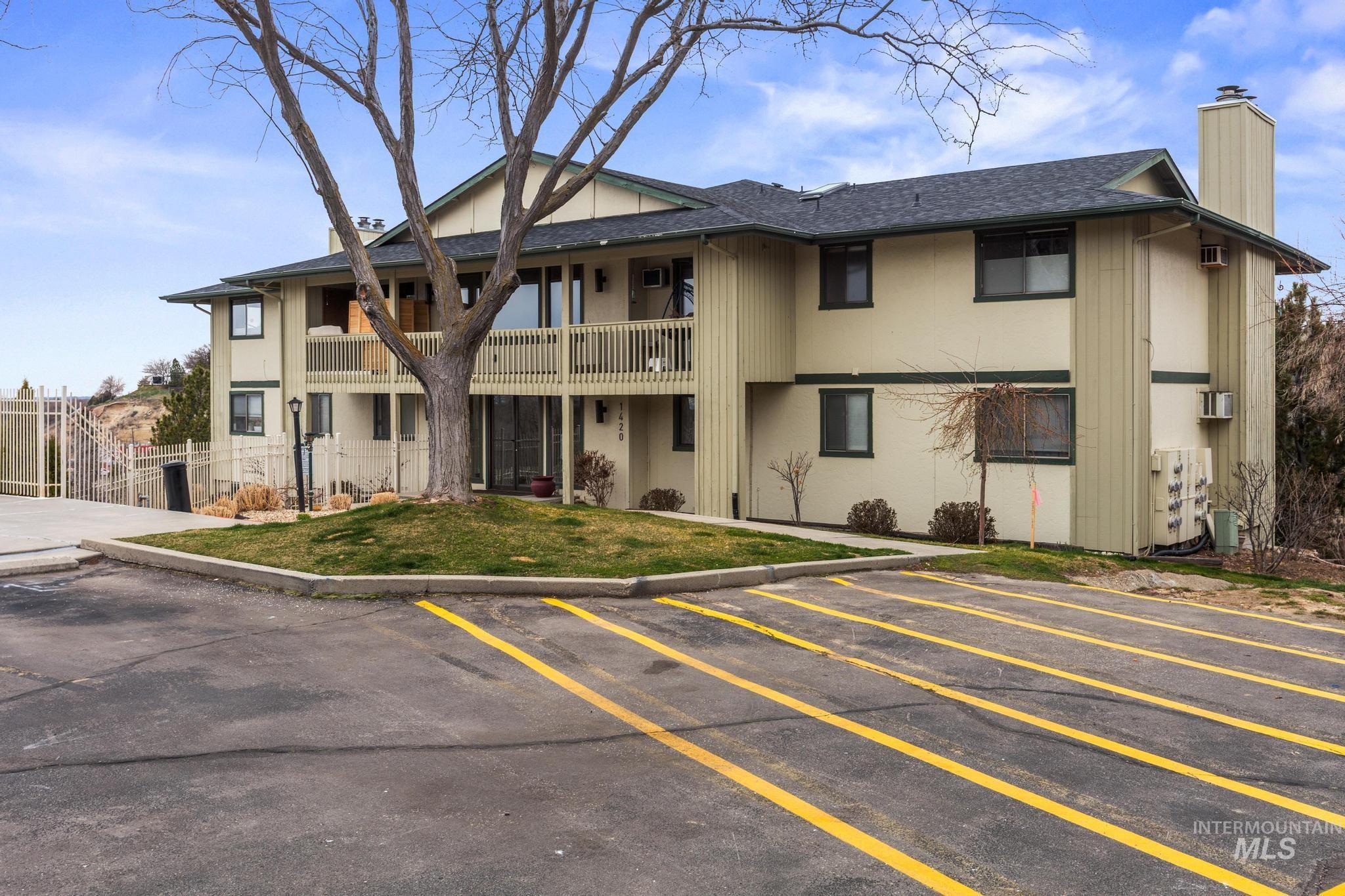 View of property featuring uncovered parking