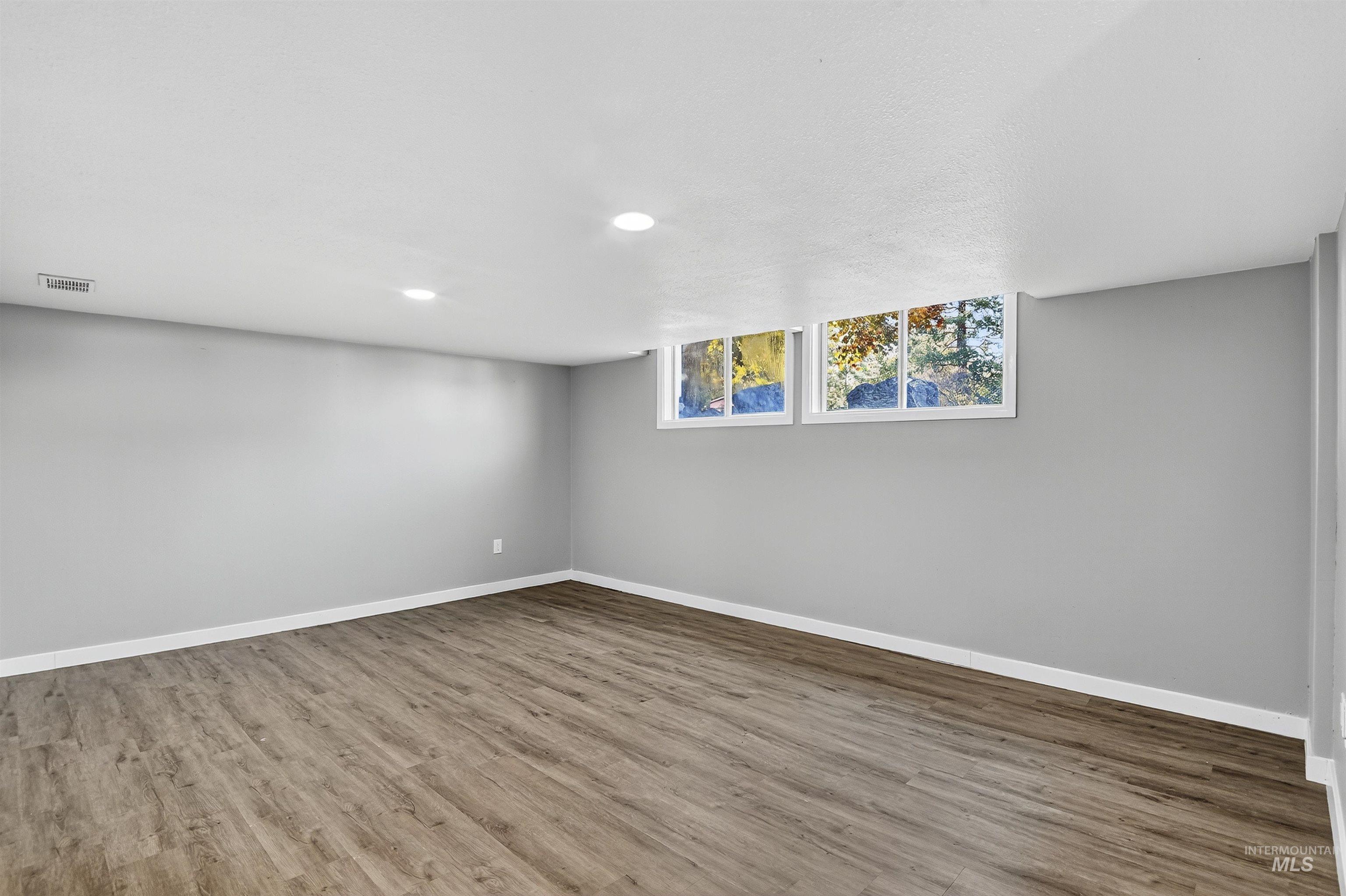 Unfurnished room featuring wood finished floors and recessed lighting