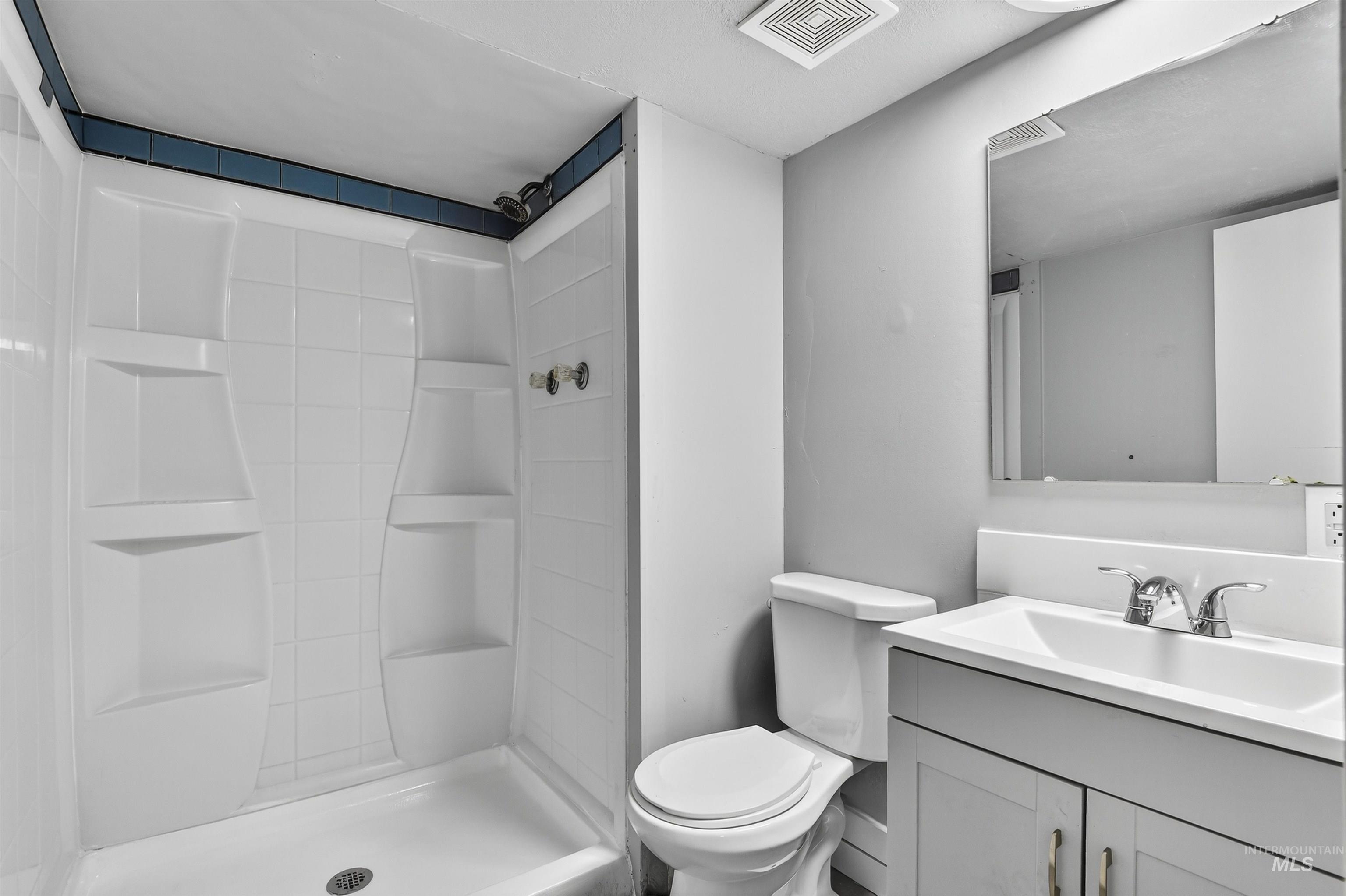 Bathroom with vanity and a shower stall