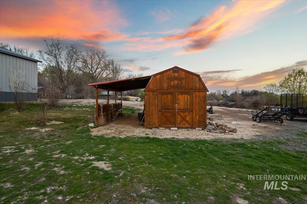 Outdoor structure at dusk with a shed