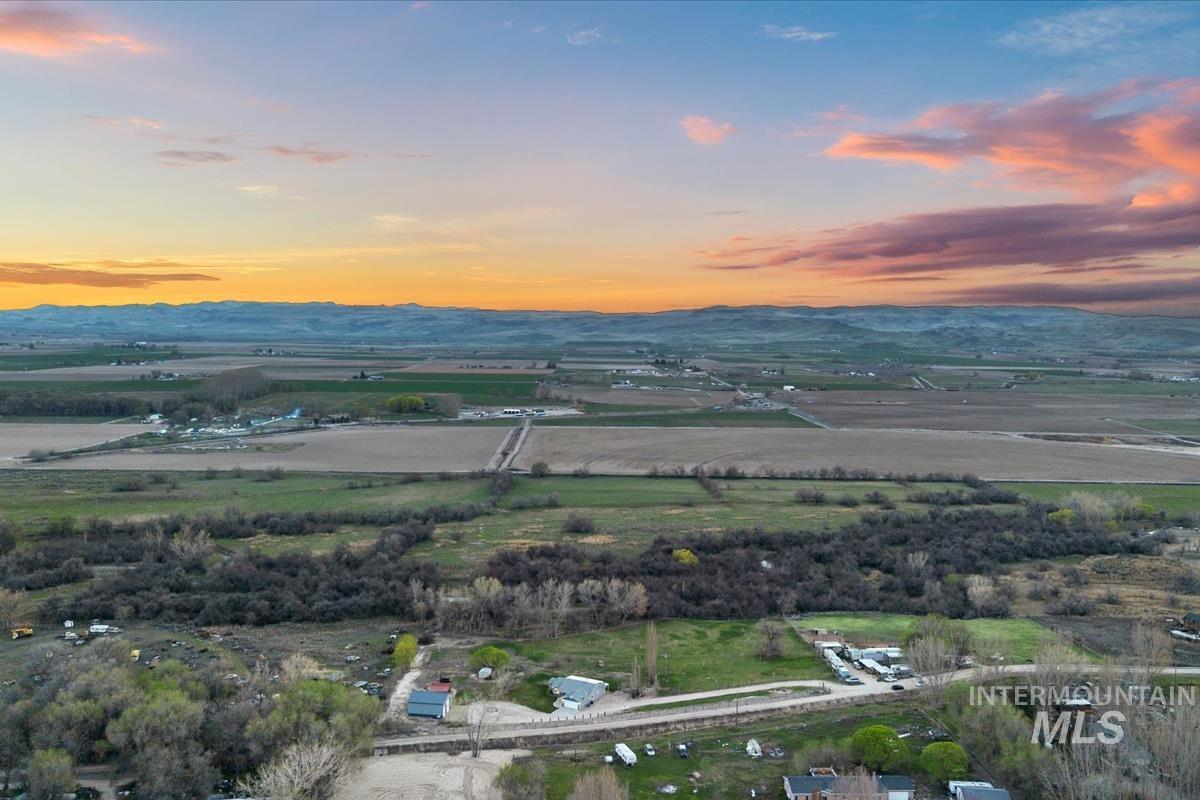 Overview of rural landscape featuring a mountainous background and farmland