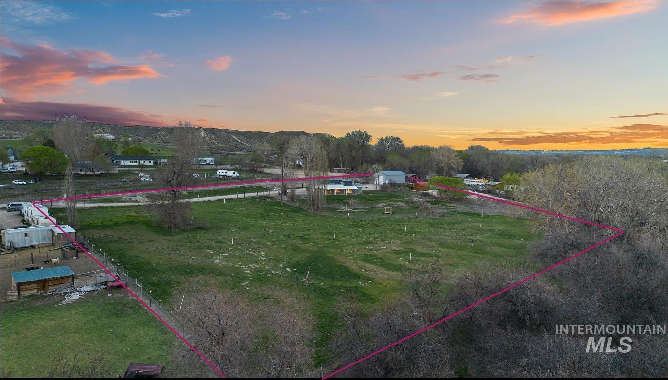 Aerial view at dusk of property parcel outlined