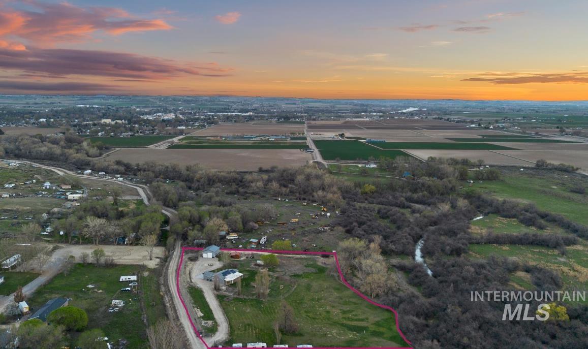 Aerial view at dusk of property parcel outlined and a view of rural / pastoral area