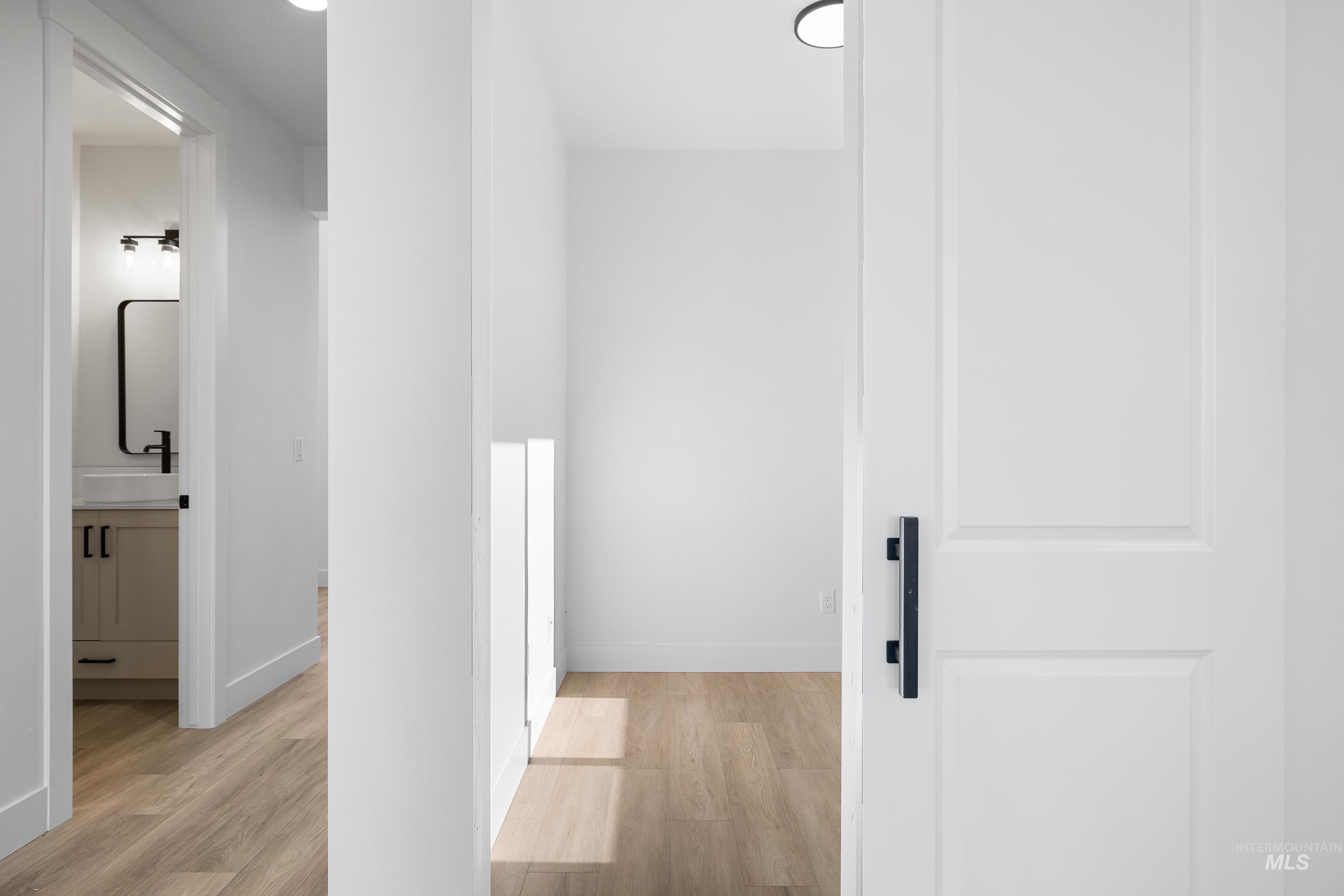 Hall featuring light wood finished floors