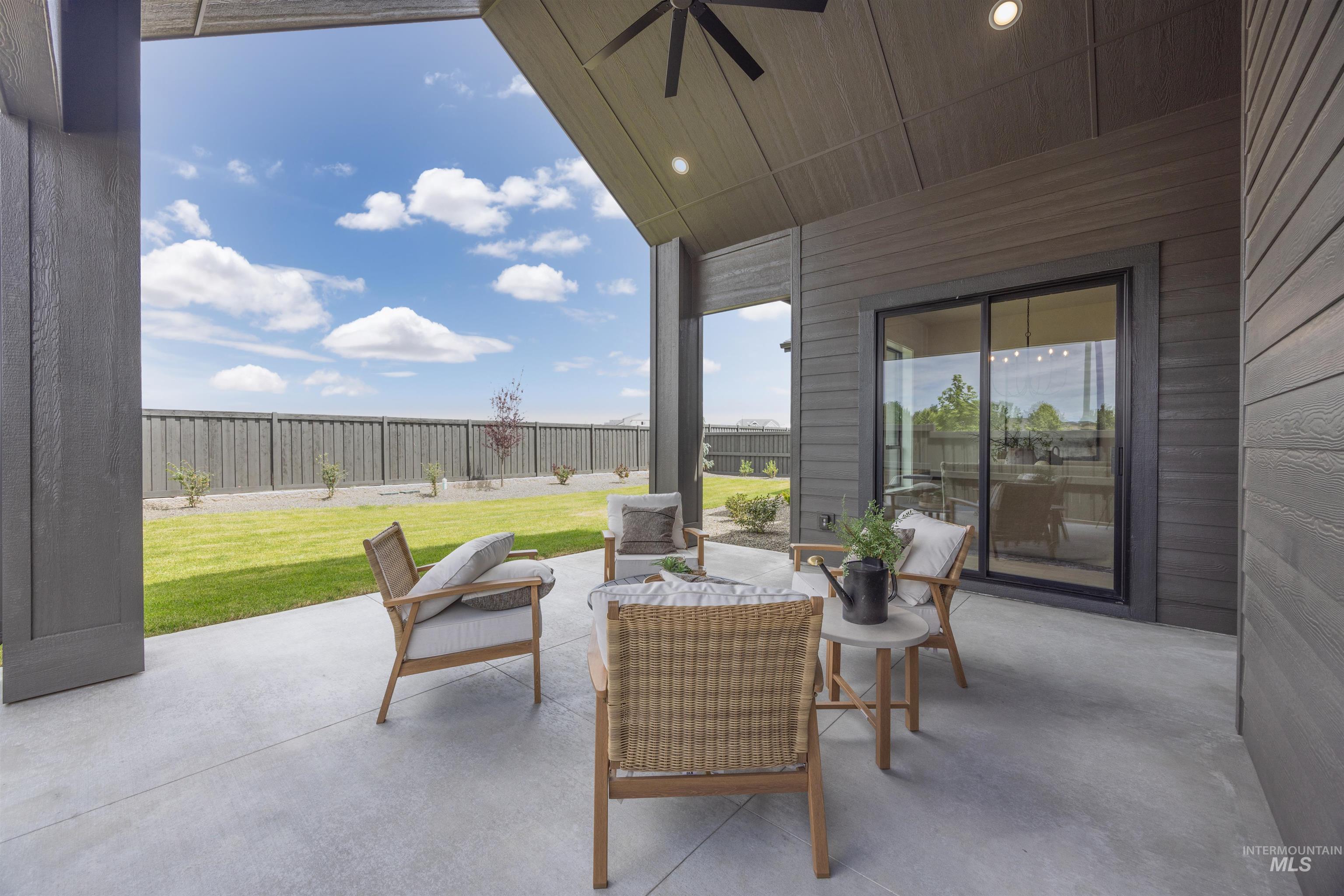 Covered patio with a concrete surface and dark wood-finish siding