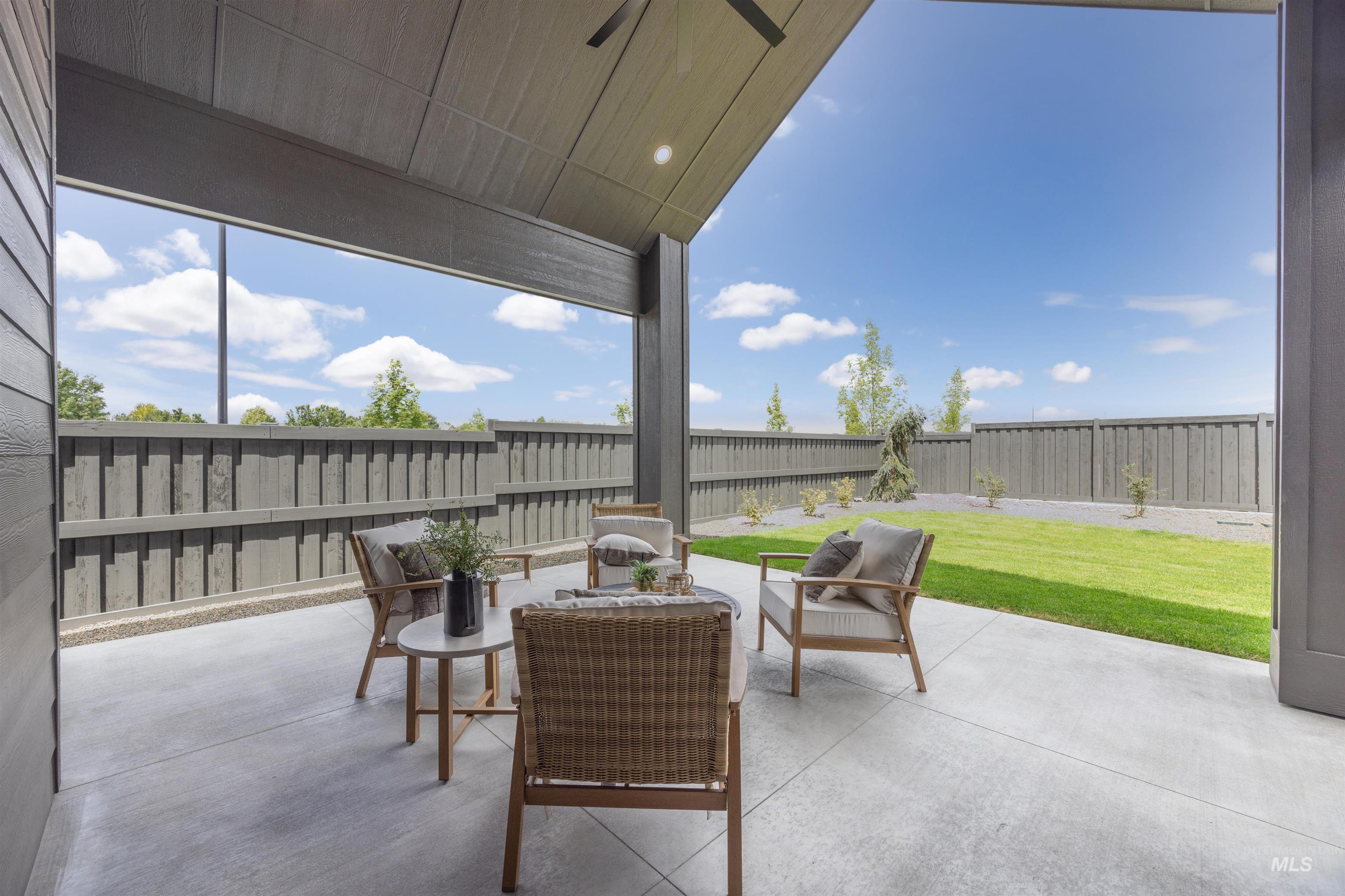 Covered patio featuring a concrete surface, overhead lighting, and wood-finish ceiling