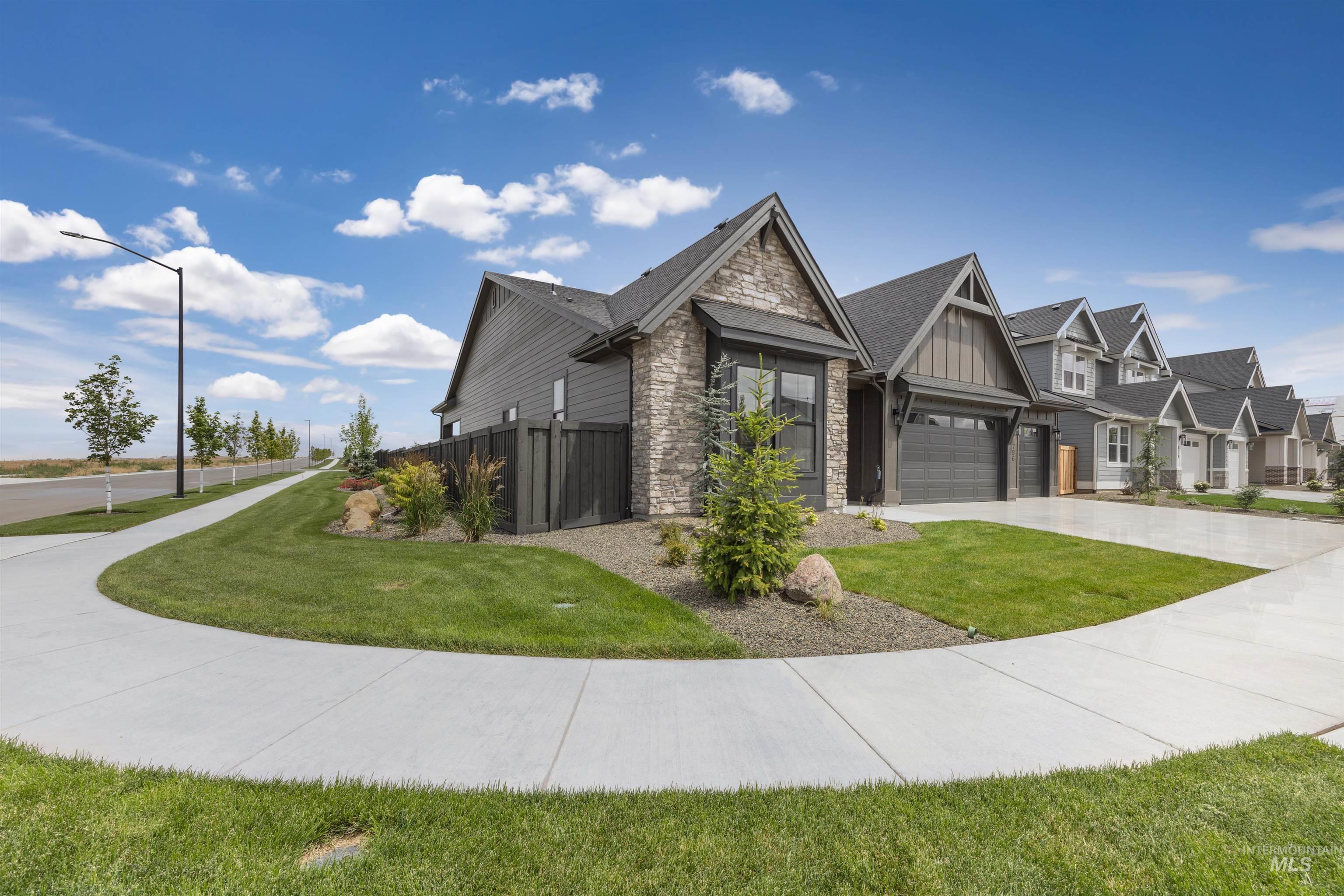 Contemporary residential exterior featuring stone veneer and horizontal siding