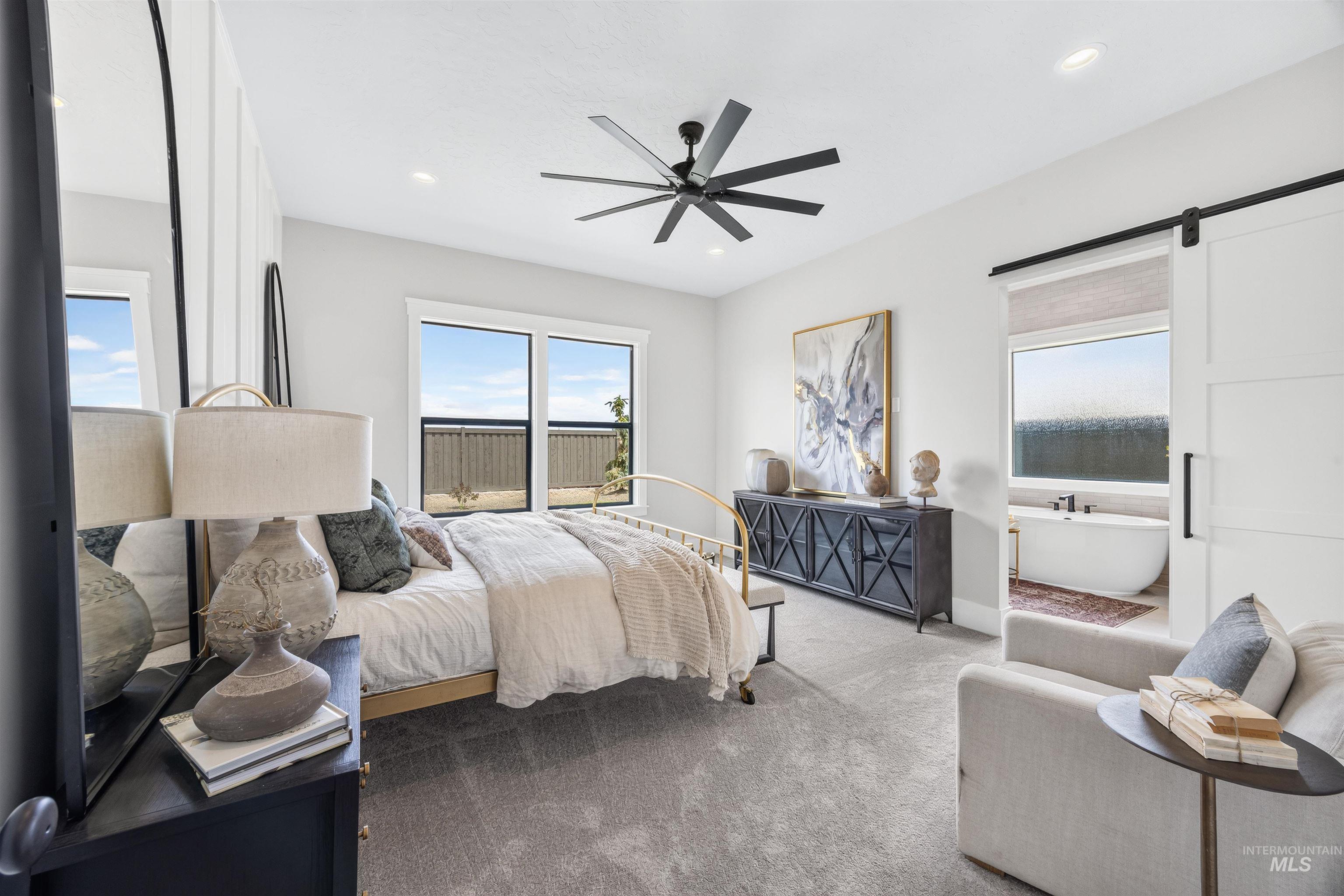Spacious room with a ceiling fan, recessed lighting, and soft gray carpeting