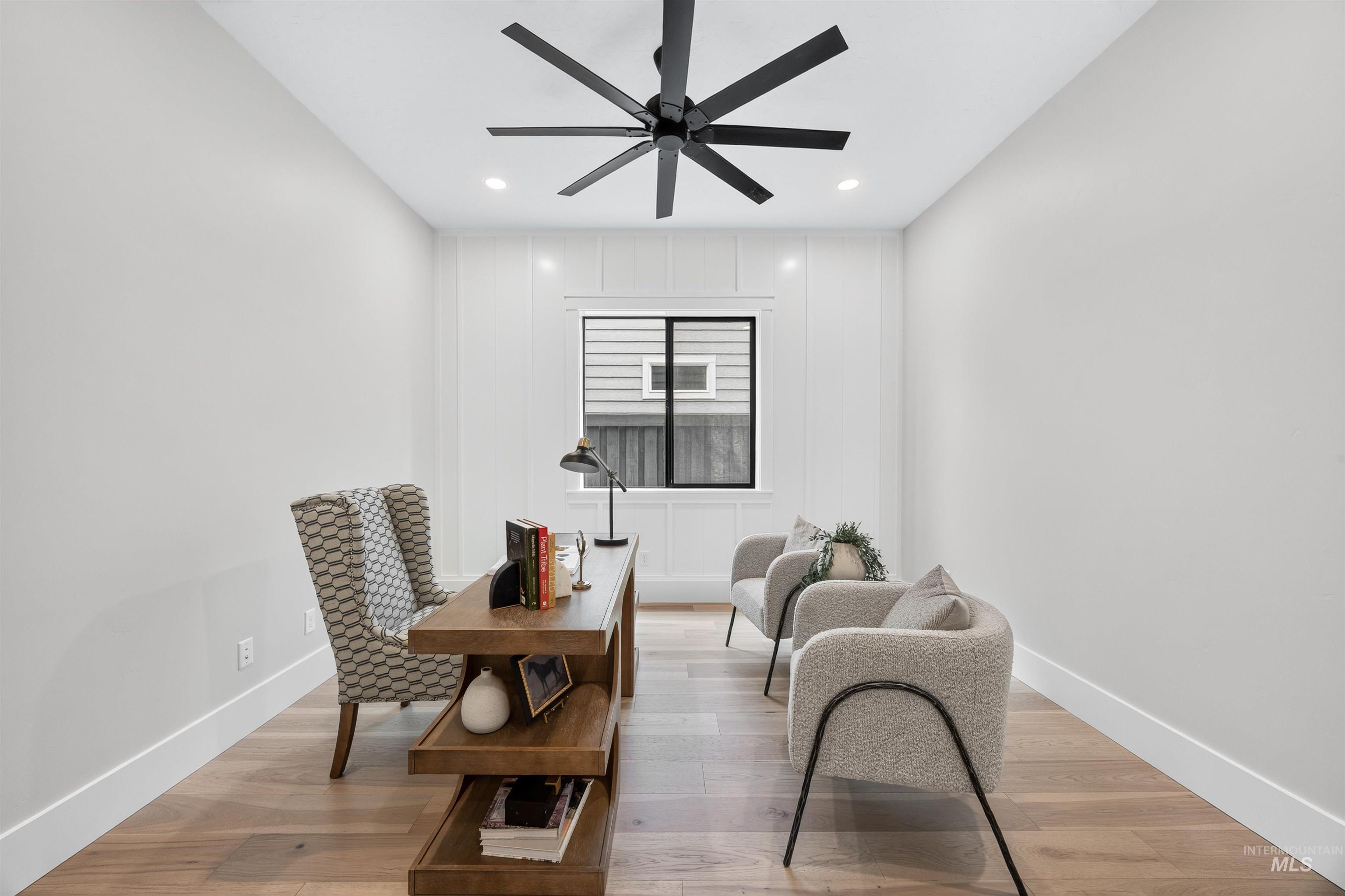 Dedicated room featuring wood-finish flooring, recessed lighting, and a modern ceiling fan