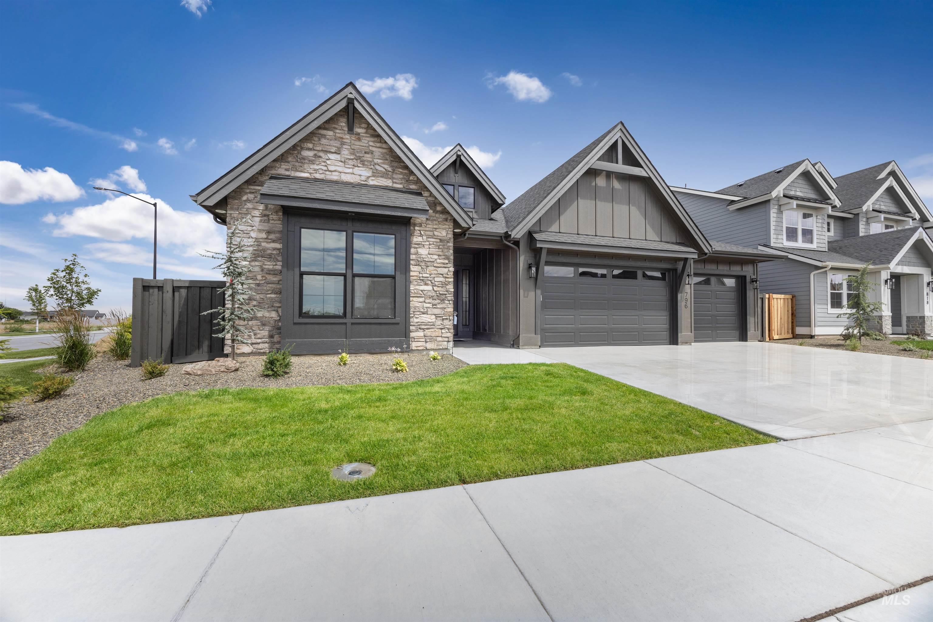 Contemporary exterior featuring stone accents and board-and-batten siding