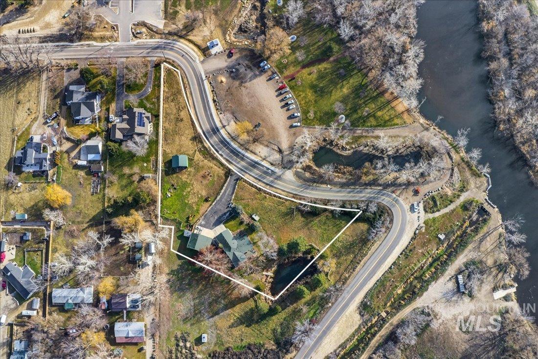 Aerial view of property's location with a nearby body of water and property boundaries highlighted