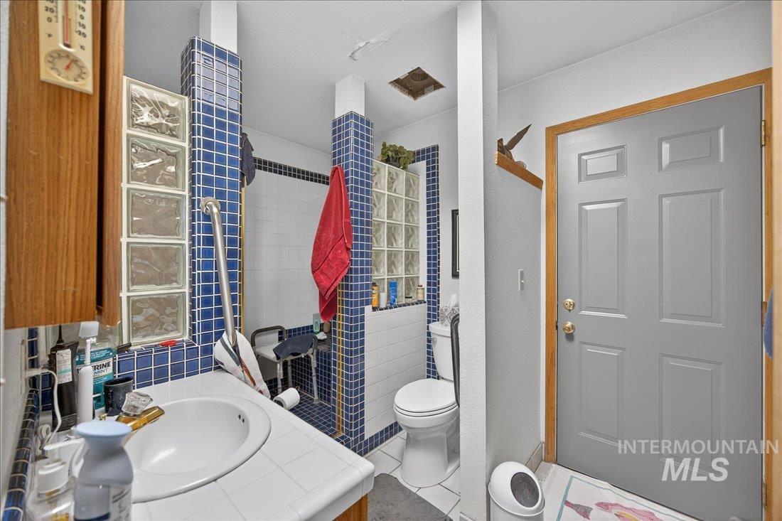 Full bathroom featuring vanity and tile shower