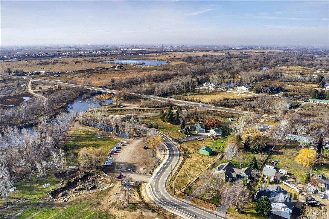Aerial view of property and surrounding area featuring a nearby body of water