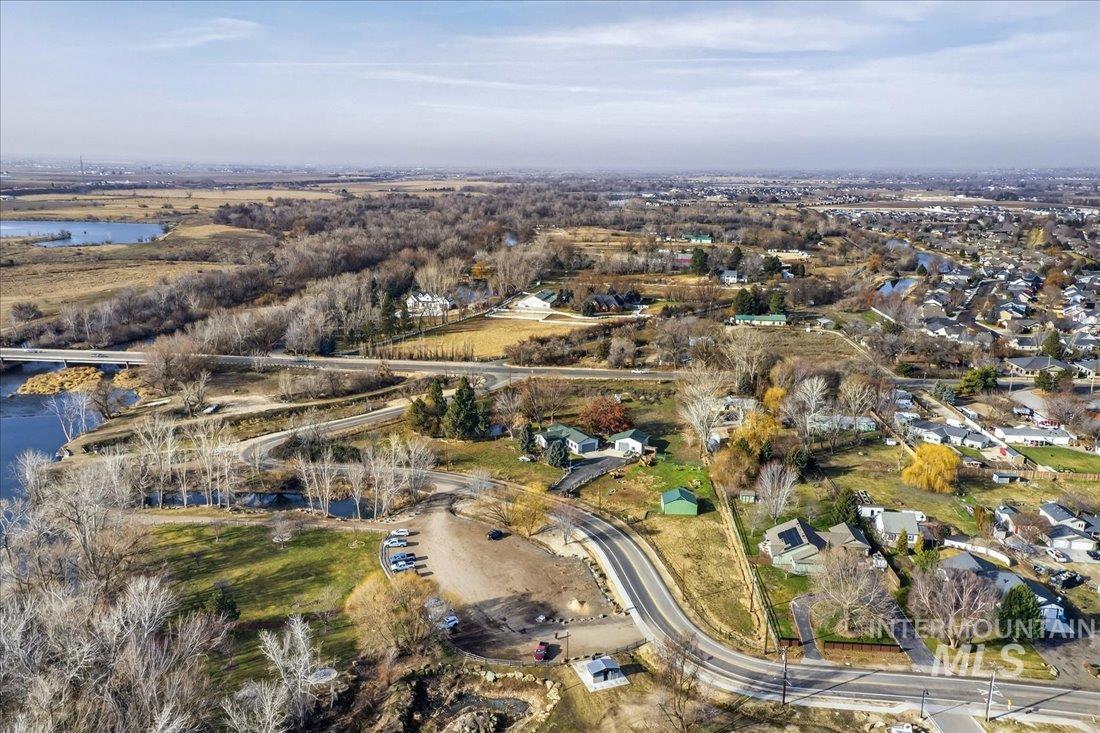 Aerial view of property's location with a nearby body of water, a notable bridge, and nearby suburban area