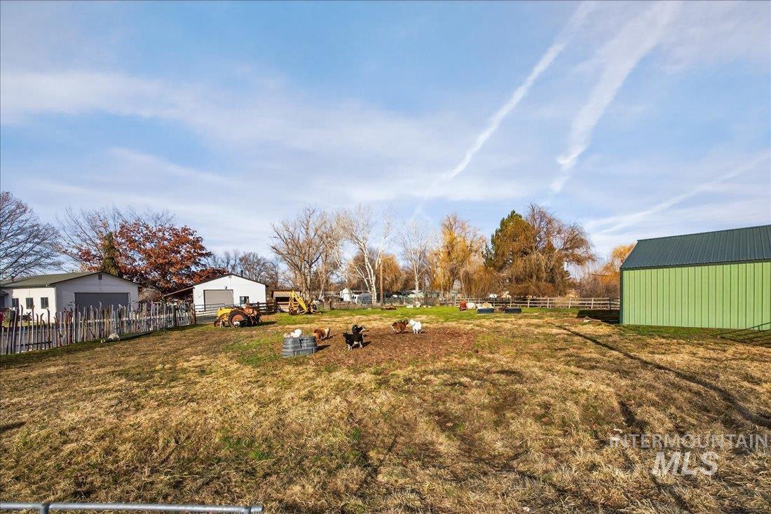 View of yard featuring an outdoor structure and a pole building