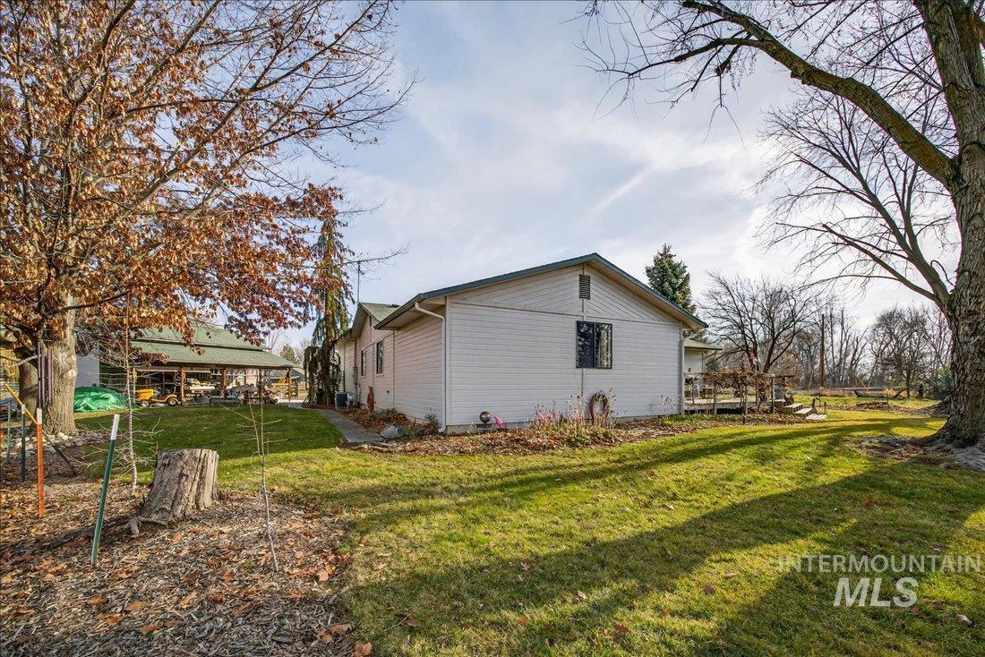 View of side of property featuring a lawn