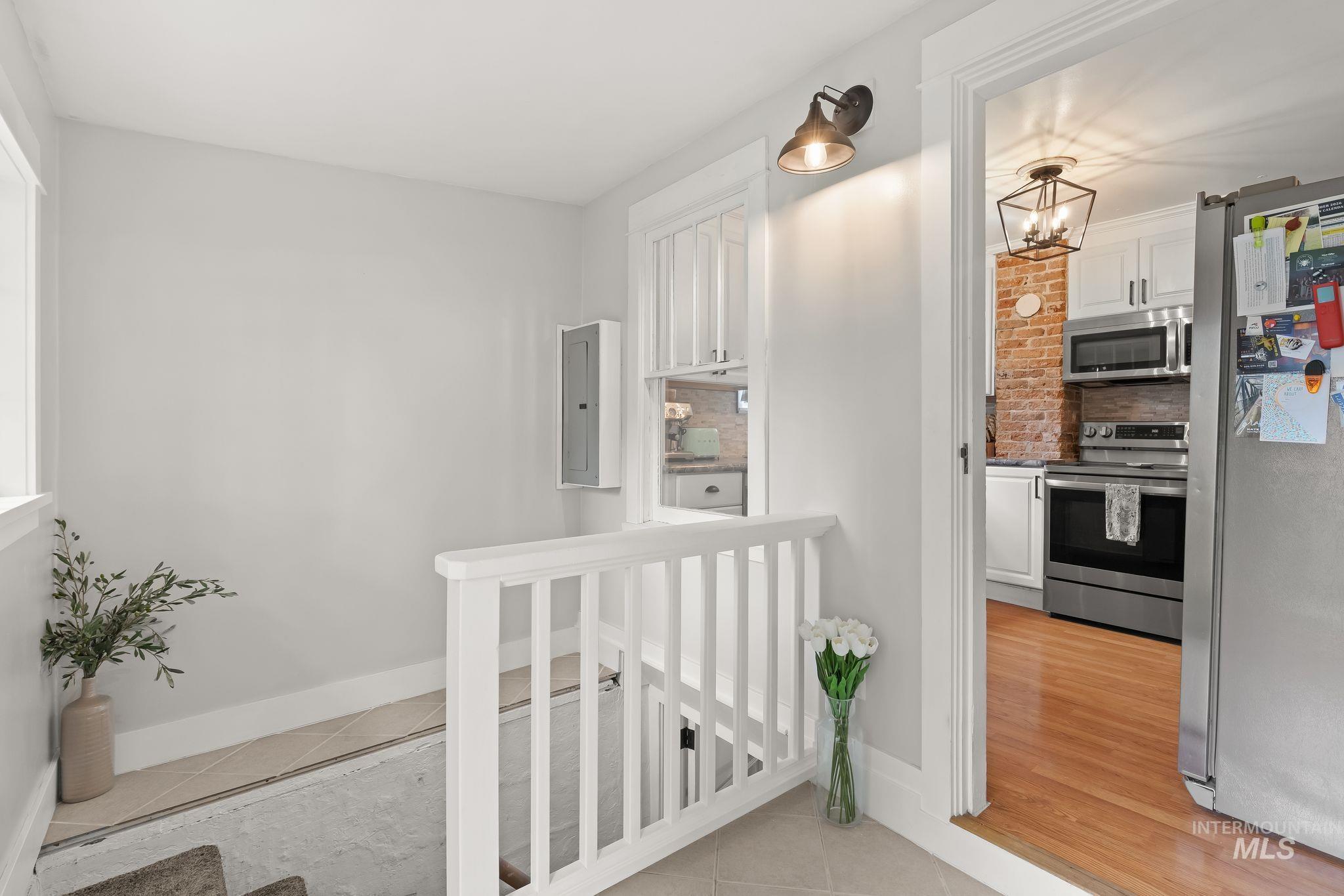 Kitchen entry framed by a white doorway and featuring wood-finish flooring