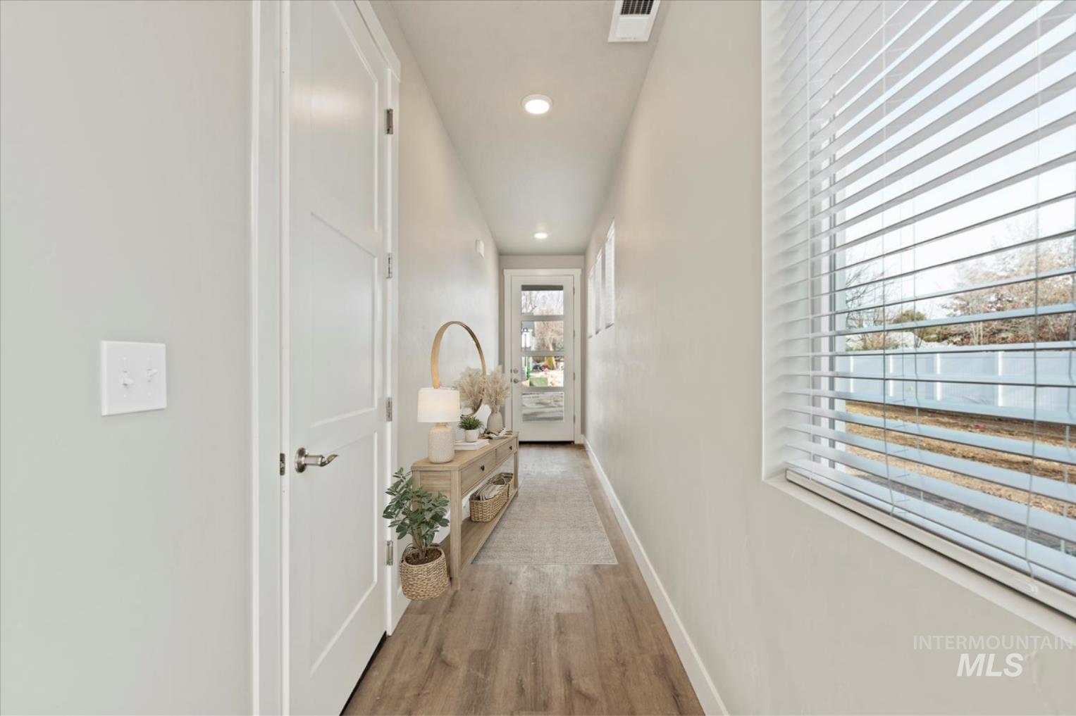 Hall featuring light wood-style flooring and recessed lighting