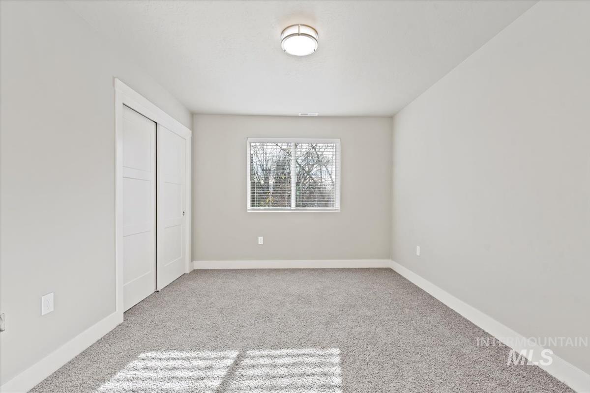 Unfurnished bedroom with a closet and light colored carpet