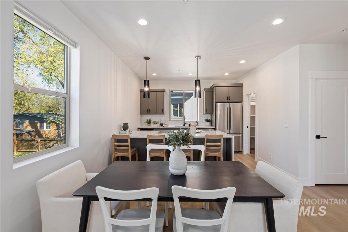 Dining space featuring light wood finished floors and recessed lighting
