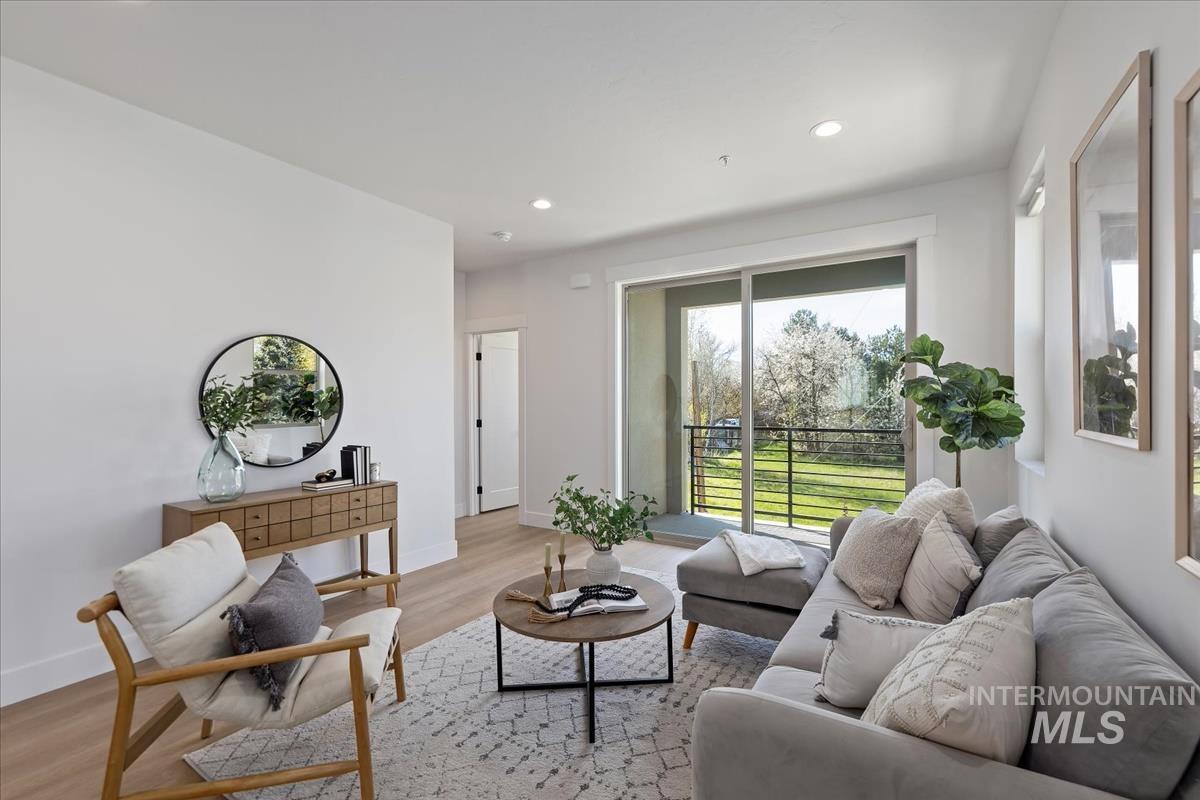 Living area featuring light wood-style floors and recessed lighting