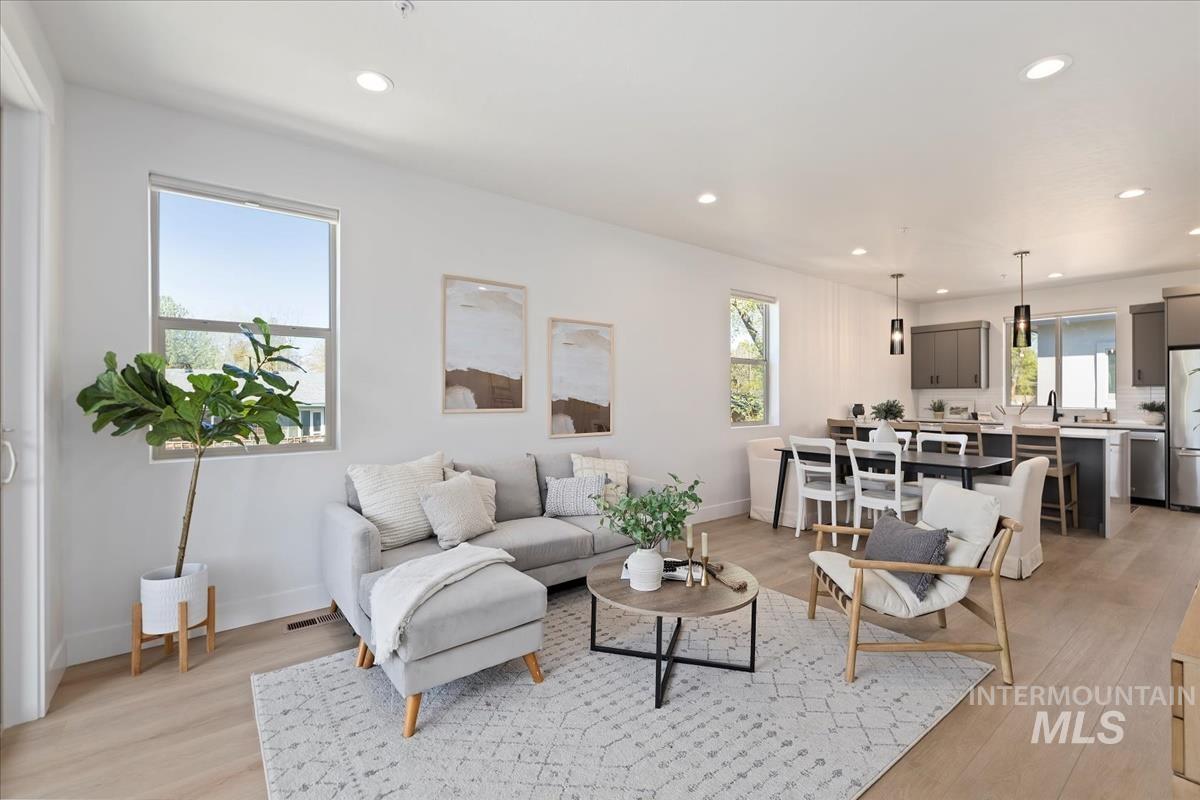 Living area featuring light wood-style flooring and recessed lighting