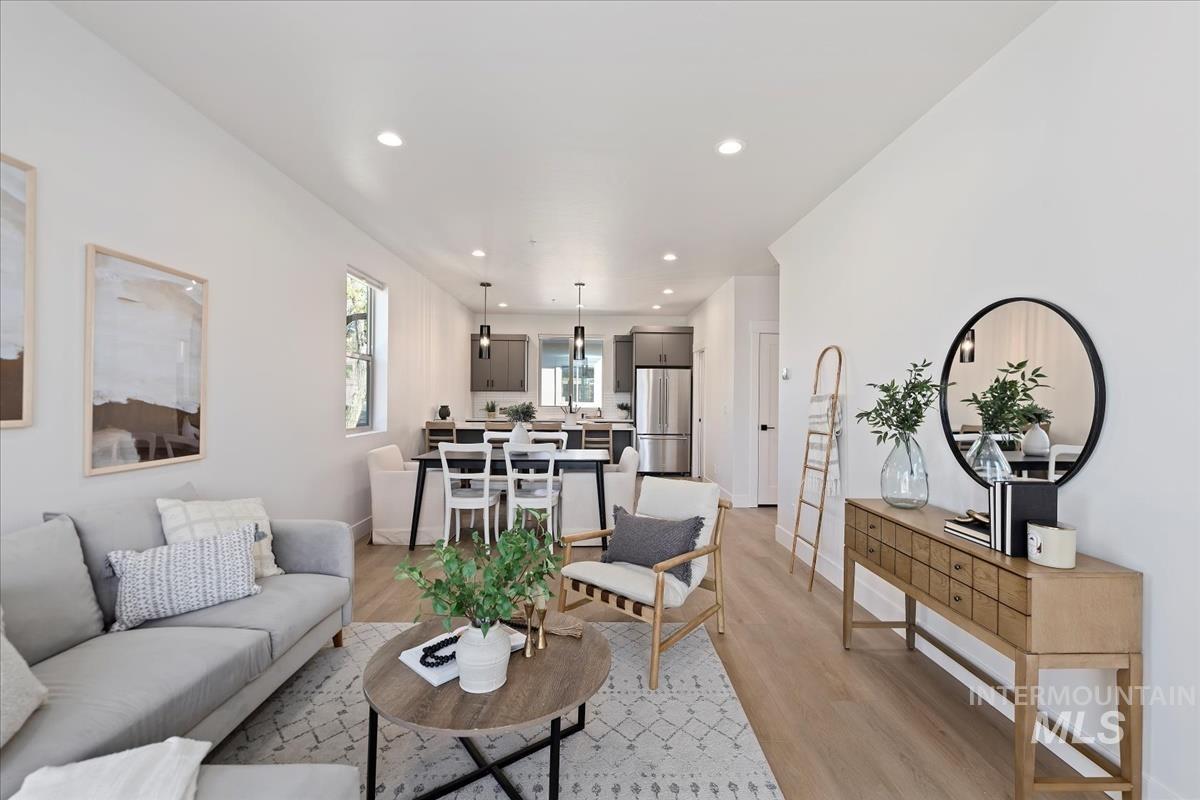 Living area featuring light wood-style floors and recessed lighting
