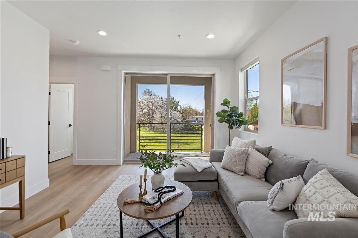 Living room featuring light wood finished floors and recessed lighting