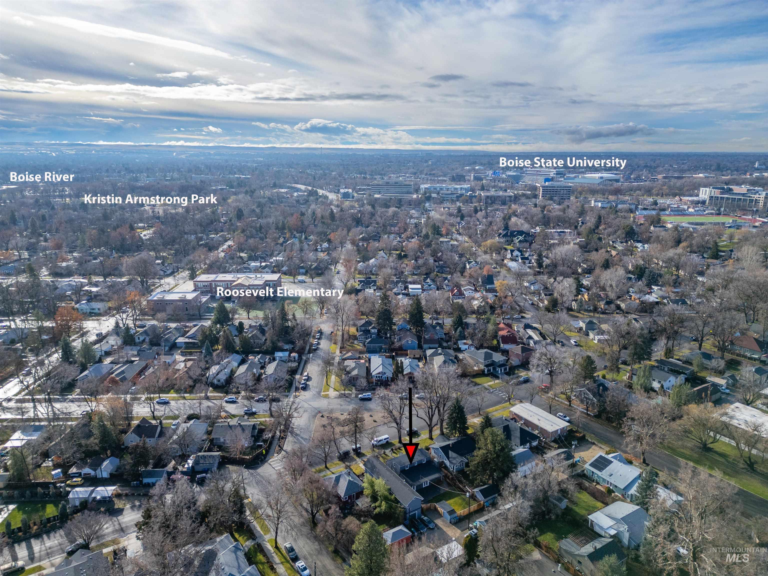 Aerial view of property and surrounding area featuring nearby suburban area