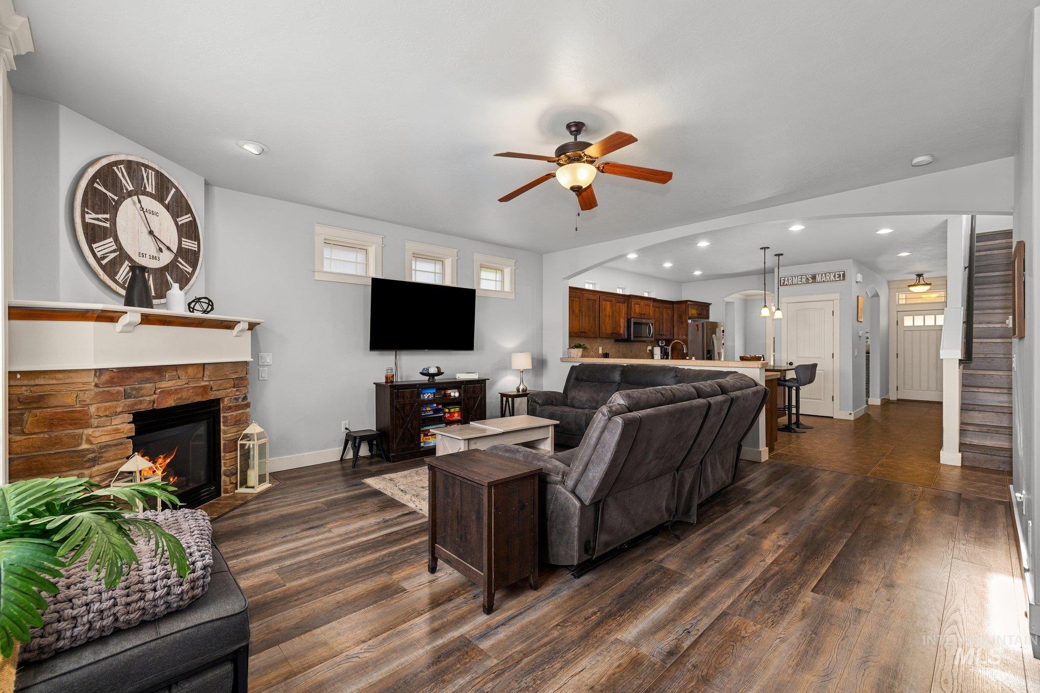 Living area featuring a ceiling fan, recessed lighting, plenty of natural light, and dark wood finished floors