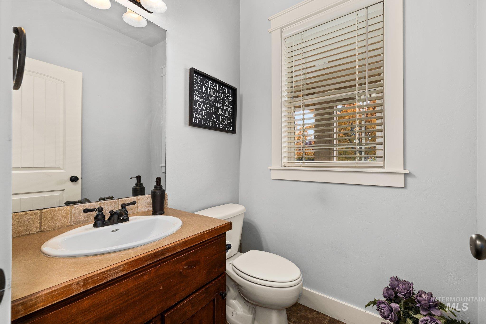 Half bathroom with vanity and toilet