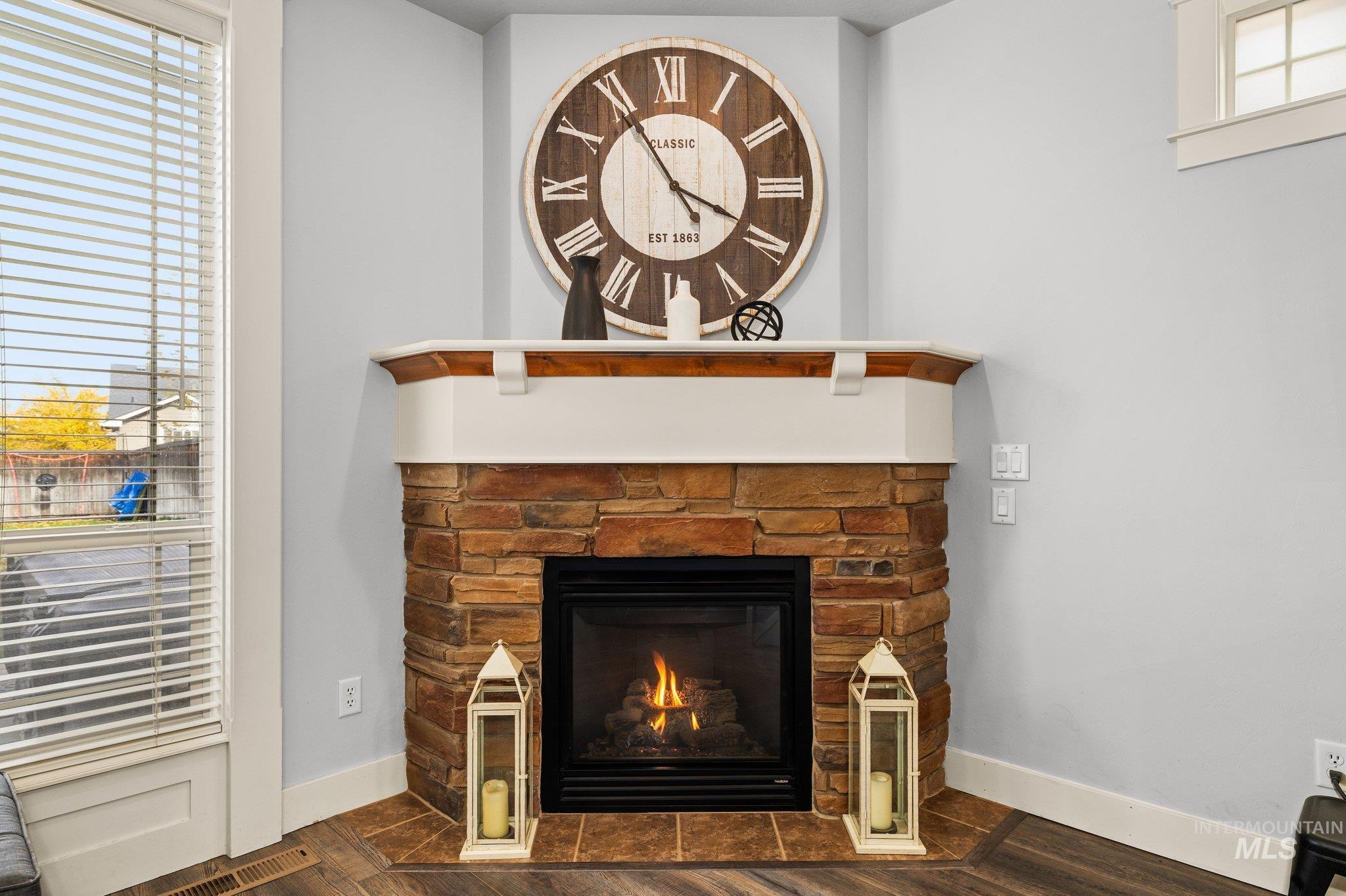 Detailed view of a fireplace and wood finished floors