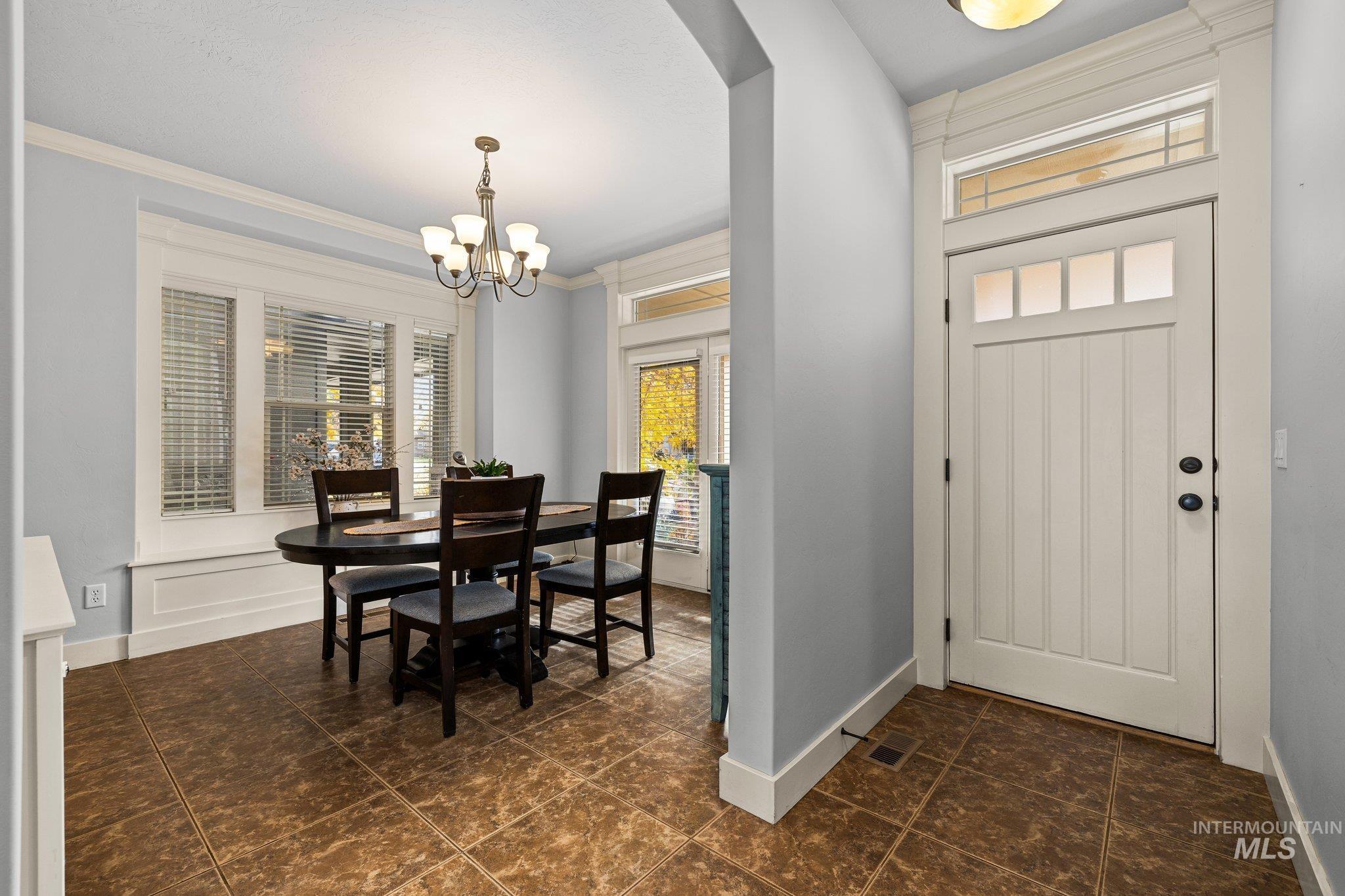 Foyer featuring crown molding and a chandelier